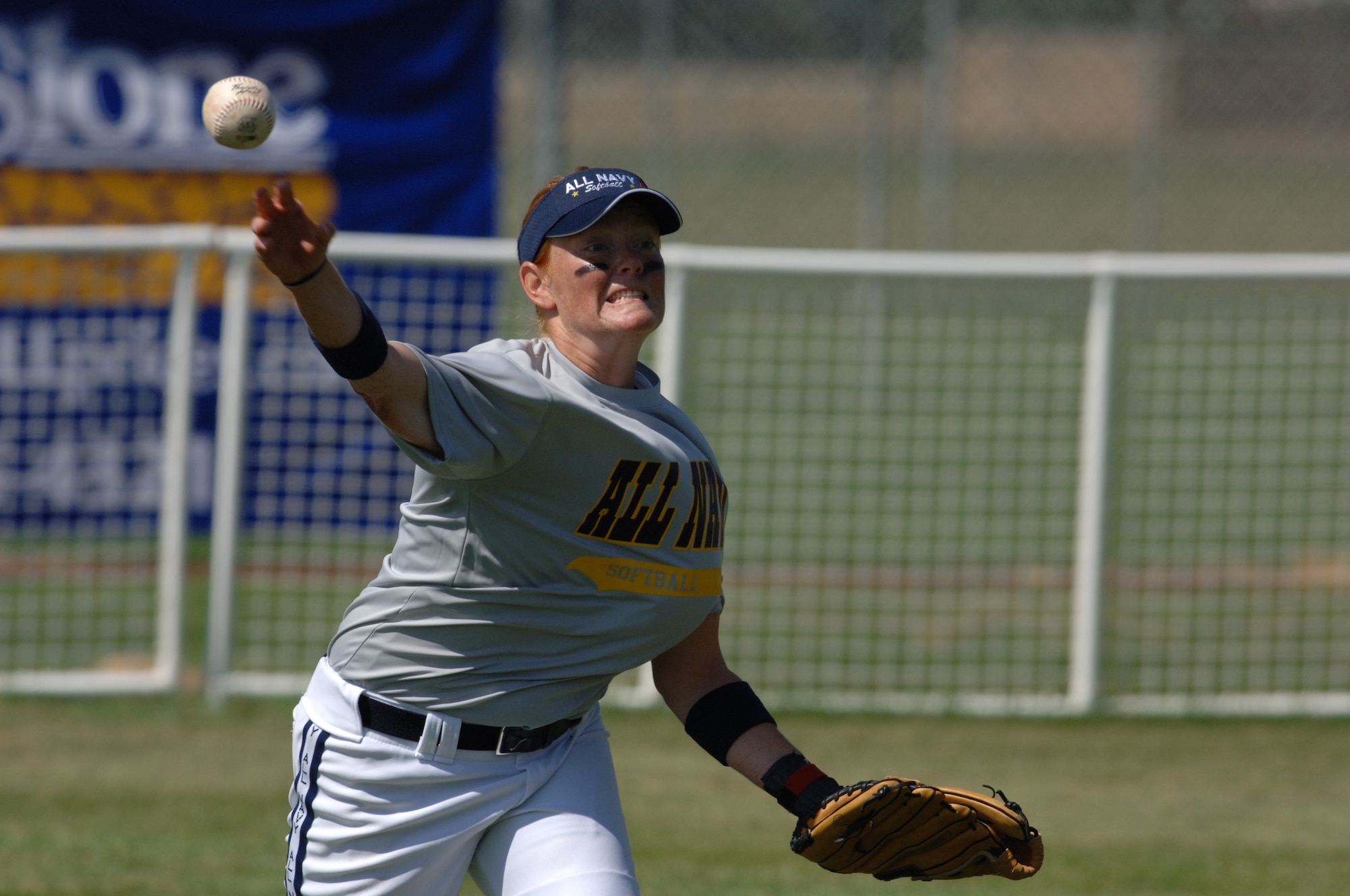 HILL AIR FORCE BASE, Utah-- Navy Seaman Jamie Strum makes a throw in an attempt to strike out her opponent during the All-Armed Forces Women’s Softball Championships The championships were held at Hill Air Force Base, Utah, Sept. 18-21. (U.S. Air Force photo by Alex R. Lloyd)
