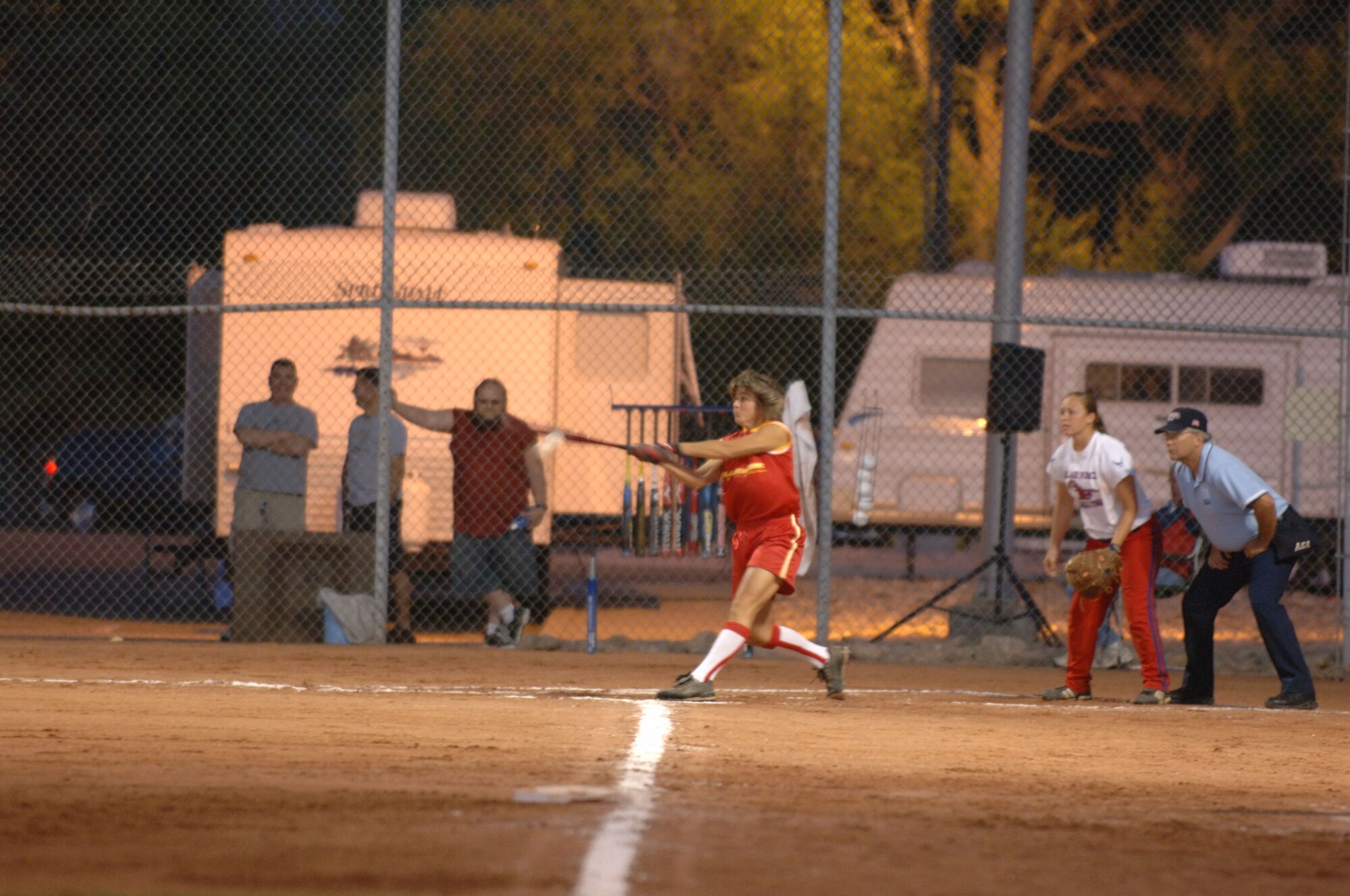 HILL AIR FORCE BASE, Utah-- Marine Corps Capt. Trish Ruf gets a hit during recent softball action as Air Force Senior Airman Carly Edwards looks on. The All-Armed Forces Women’s Softball Championships were held at Hill Air Force Base, Utah Sept. 18-21. (U.S. Air Force photo by Alex R. Lloyd)
