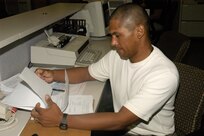 Juan Santos, 37th Logistics Readiness Squadron transportation specialist at Lackland Air Force Base, Texas, reviews a budgeting analysis report. Mr. Santos is a participant in the Palace HART program, an Air Force program designed to assist disabled veterans in federal job placement and civilian life after the military. (USAF photo by Staff Sgt. Vincent Borden)
