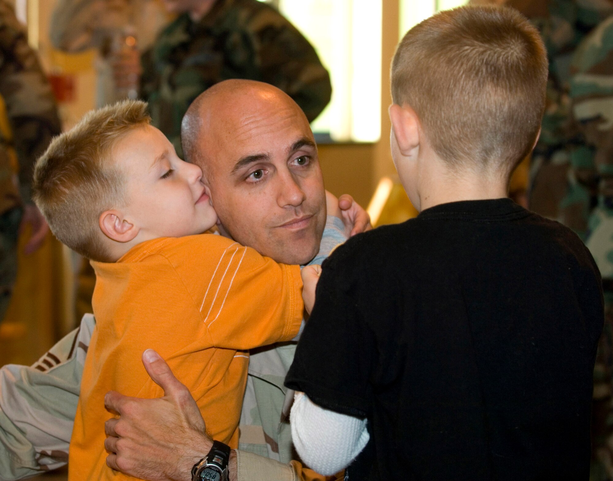 Master Sgt. Noah Wood is welcomed home by his two sons, Dekota and Dylan, Sept. 17 to Elmendorf Air Force Base, Alaska. Approximately 40 Airmen returned home to their friends and families from supporting the war on terrorism in Southwest Asia. (U.S. Air Force photo/Senior Airman Garrett Hothan)
