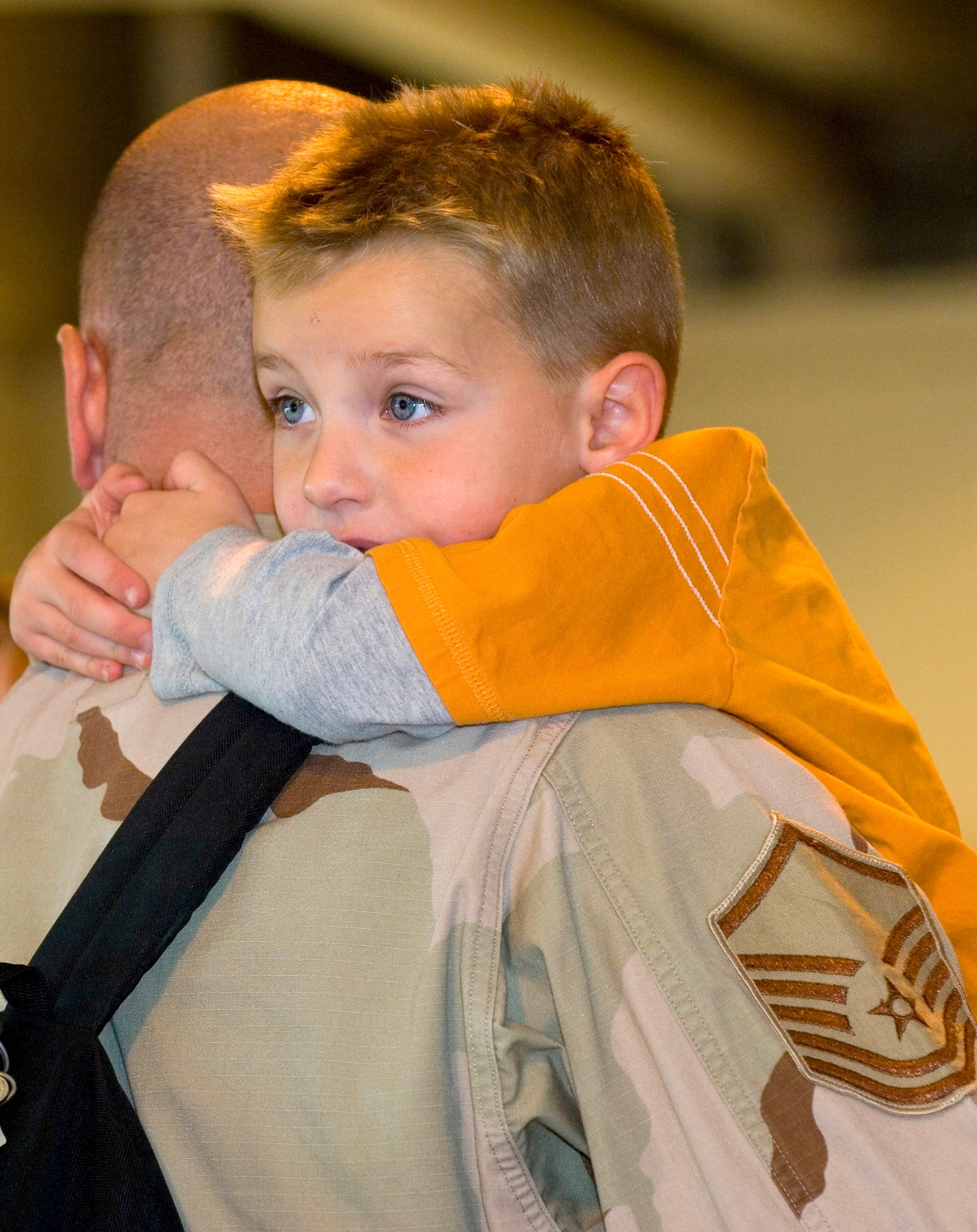 Dekota Wood hugs his father, Master Sgt. Noah Wood, who just arrived home at Elmendorf Air Force Base, Alaska, Sept. 17 after being deployed in Southwest Asia supporting the war on terrrorism. Approximately 40 deployed Airmen were greeted by friends and family at the joint military complex. (U.S. Air Force photo/Senior Airman Garrett Hothan) 
