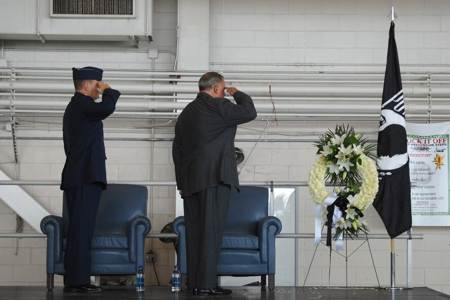 Colonel Brad Webb, 1st Special Operations Wing Commander, and retired Colonel Howard Hill salute the American flag and the POW/MIA wreath during a POW/MIA ceremony in the Freedom Hanger of Hurlburt Field, FL on Sept. 14, 2007. Col Hill was this years guest speaker and talked about his experience as a POW in Vietnam. (U.S. Air Force by Senior Airman Juliane Showalter)