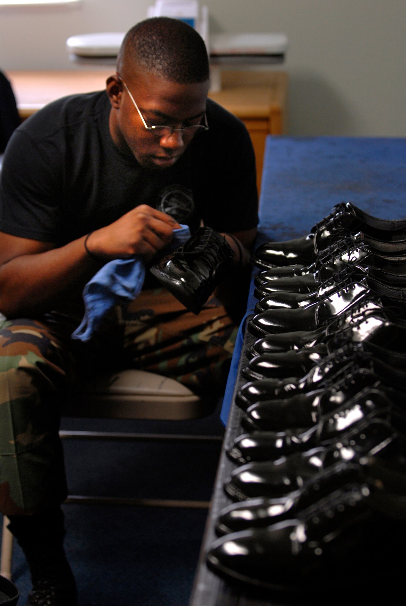 Luke Honor Guard member Senior Airman Donald Hypolite, 56th Equipment Maintenance Squadron, works on his low quarters. (photo by Senior Airman Christopher Hummel)