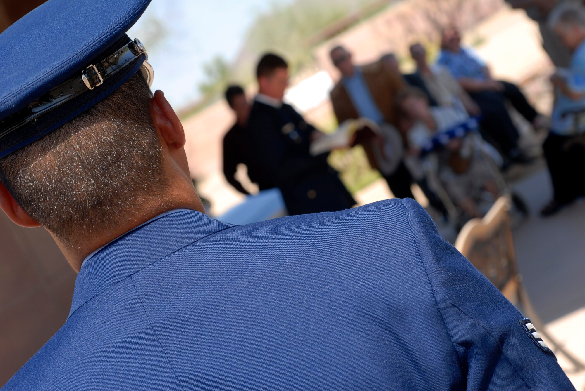 Luke Honor Guard member Senior Airman Kamanu Fernandez, 56th Component Maintenance Squadron, waits to present the expended rounds from the 21-gun salute to next of kin. (photo by Senior Airman Christopher Hummel)