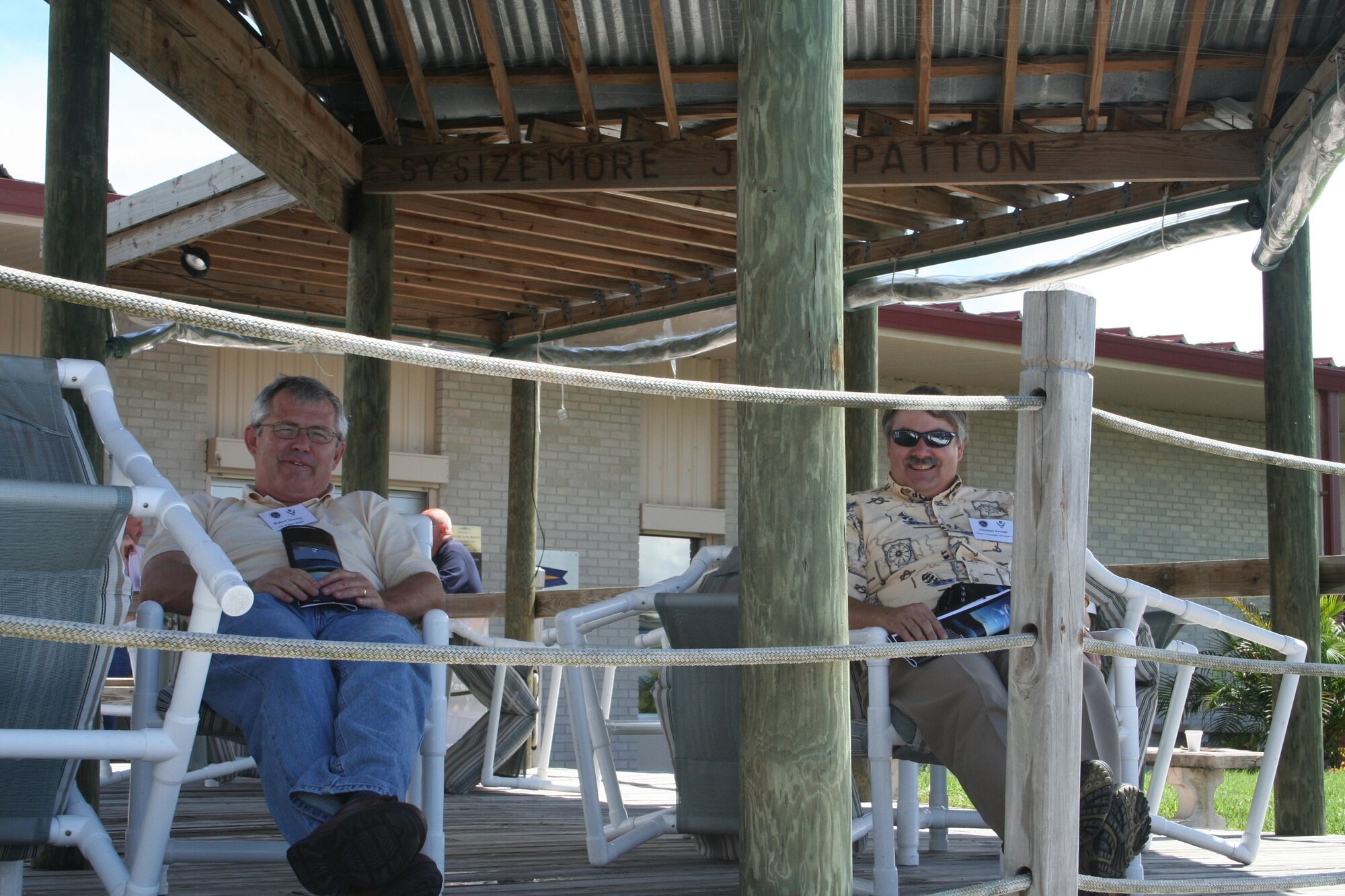 PATRICK AFB, Fla. - Wright-Patterson AFB Civic Leaders Robert Murray, left, and Michael Savage, right, take a moment before lunch to relax on the deck at the Patrick AFB, Fla. Marina.  The 445th Airlift Wing and the 88th Air Base Wing hosted the civic leaders on a C-5 Galaxy flight to Patrick AFB, Fla. to enhance community awareness of the total force mission. (U.S. Air Force photo/Laura Darden)     