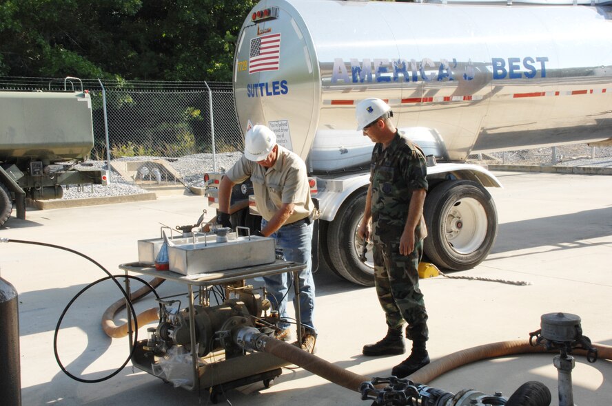 Tech. Sgt. Michael Dambrino,
704th Mission Support Group, Logistics office, watches as Aerospace Testing Alliance's Sam McKelvey operates the fuel additive injection rig, which adds chemicals to the FT fuel to prevent corrosion and icing, while improving the lubricity of the fuel. (AEDC photo)