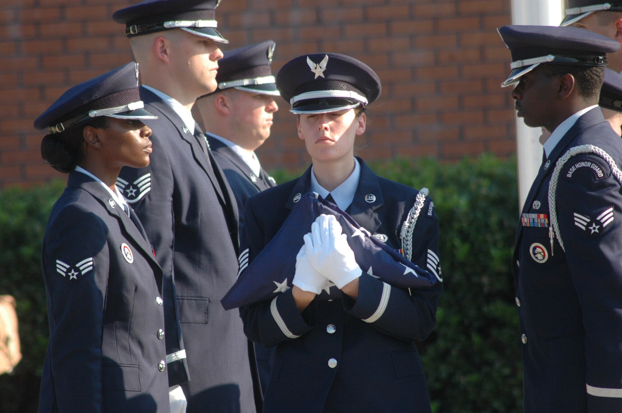 Staff Sgt. Shannon Lampo, a member of the Robins Honor Guard, secures the flag.  U.S. Air Force photo by Sue Sap