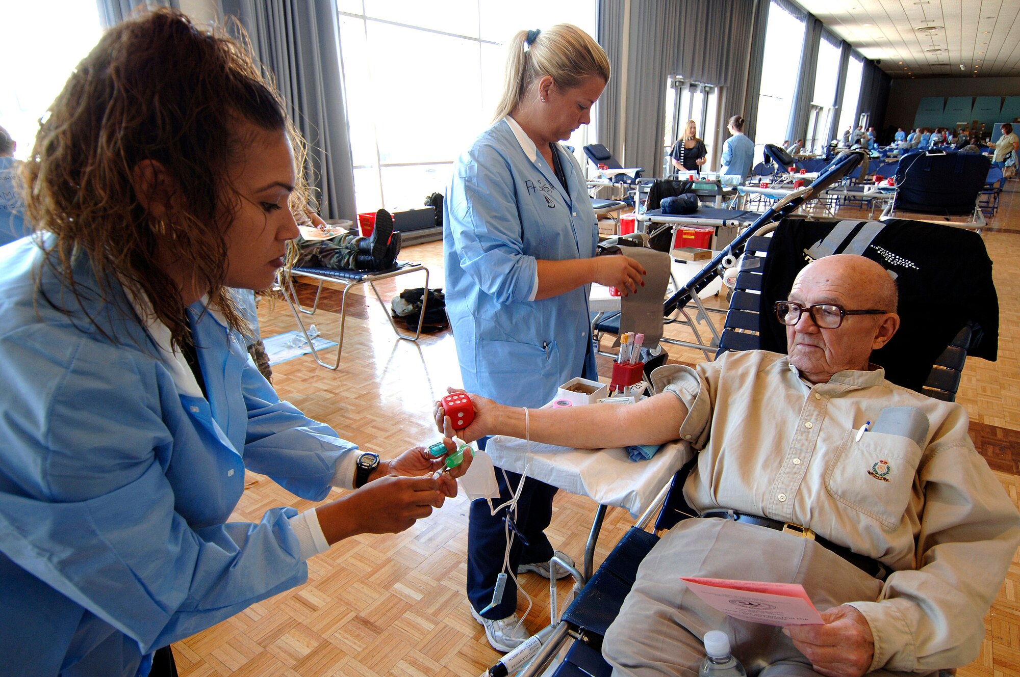 Retired Army Capt. George Froemke donates blood during a blood drive held in the Arnold Hall ballroom Sept. 19 at the U.S. Air Force Academy in Colorado. Blood collected will benefit armed forces members by helping to meet the urgent needs of wounded Americans in Iraq and Afghanistan. (U.S. Air Force photo/Mike Kaplan) 
