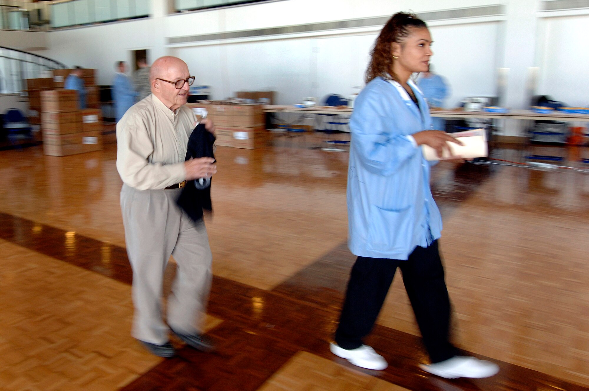 Retired Army Capt. George Froemke, a veteran of World War II, South Korea and Vietnam, is escorted to donate blood during a blood drive held in the Arnold Hall ballroom Sept. 19 at the U.S. Air Force Academy in Colorado. Blood collected will benefit armed forces members by helping to meet the urgent needs of wounded Americans in Iraq and Afghanistan. (U.S. Air Force photo/Mike Kaplan) 
