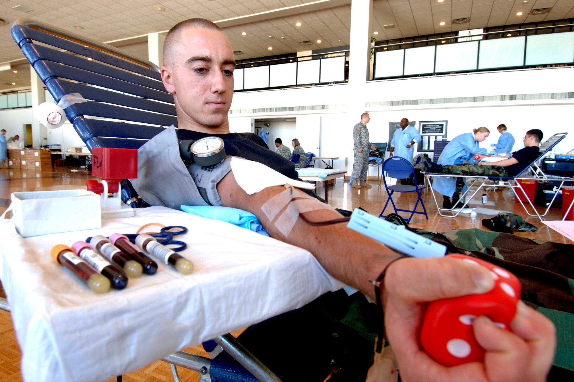 Cadet 2nd Class Nathaniel Nocalis donates blood during a blood drive held in the Arnold Hall ballroom Sept. 19 at the U.S. Air Force Academy in Colorado. Blood collected will benefit armed forces members by helping to meet the urgent needs of wounded Americans in Iraq and Afghanistan. (U.S. Air Force photo/Mike Kaplan)
