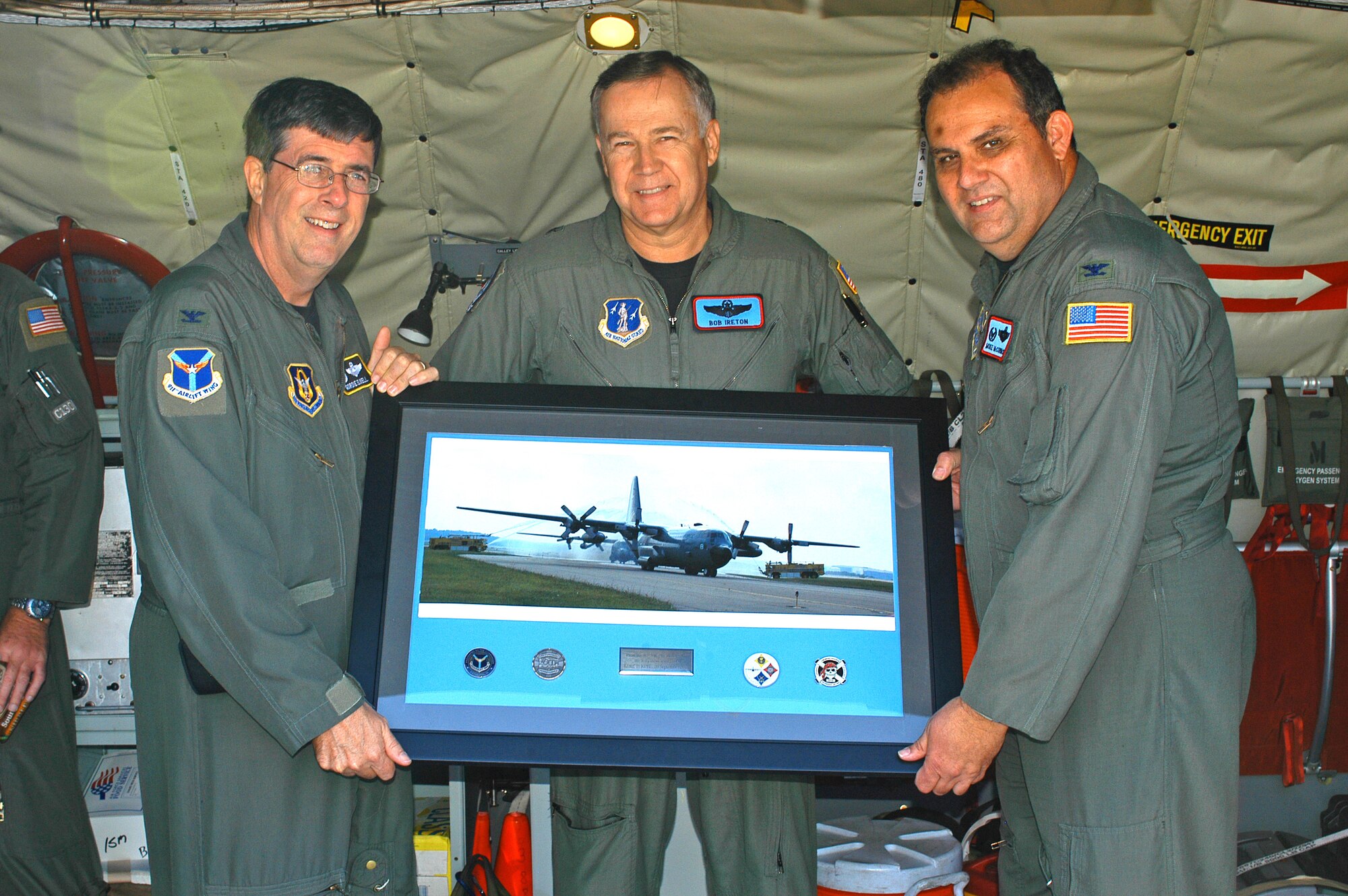 PITTSBURGH AIR RESERVE STATION, Pa. --  A plaque commemorating the arrival of the final three C-130H2 Hercules aircraft delivered from the 137th Airlift Wing to the 911th Airlift Wing is presented to the Oklahoma National Guard Commander from the 911 AW Commander Sep. 21, 2007. FROM LEFT TO RIGHT: Col. Gordon Elwell, 911 AW/CC, Brig. Gen. Robert Ireton, OANG/CC, Col. Mike McCormack, 137 AW/CC. (AF photo by Staff Sgt. Ian Carrier)                          