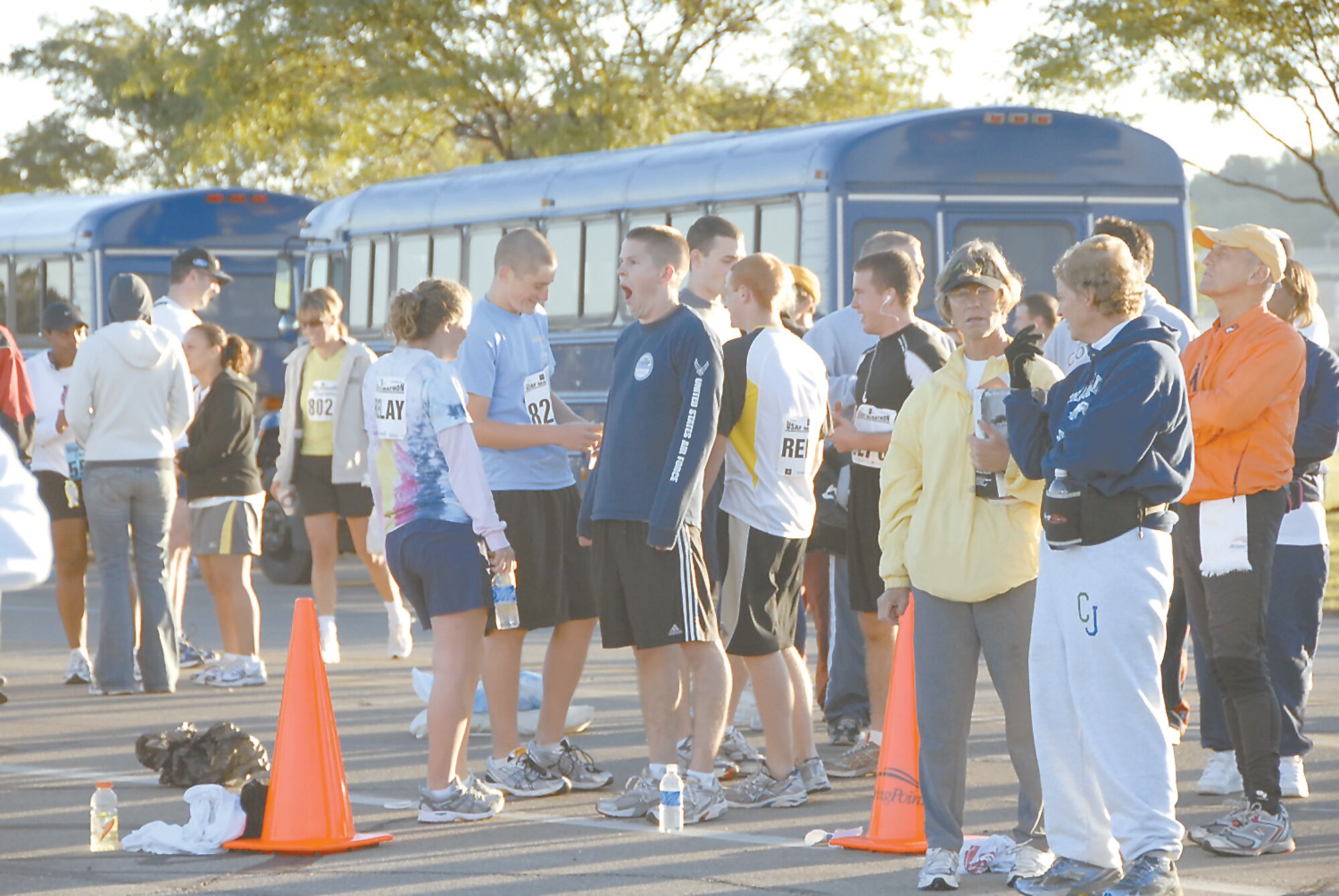 A sleepy relay runner yawns as he waits with groups of relay members to board busses to get to their stations for the race. Skywrighter photo by Christy Webb.