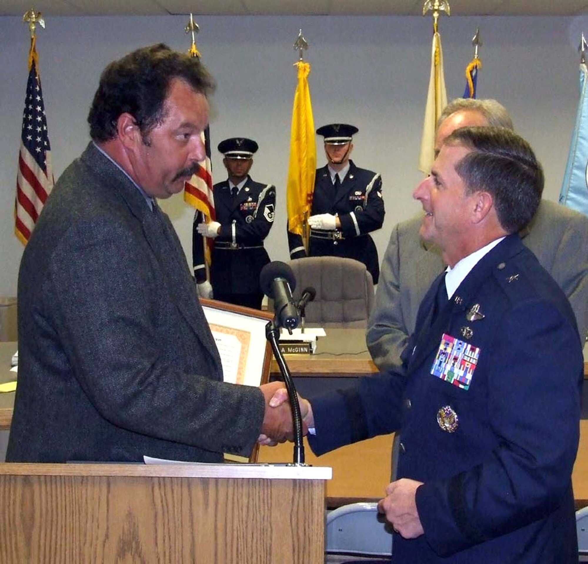 Mr. Doug Moore, chairman of the Otero County Board of Commissioners, hands a proclamation to Brig. Gen. David Goldfein, 49th Fighter Wing commander. The proclamation recognizes September 2007 as Air force Month in Otero County. (U.S. Air Force photo/Mr. Rob Sexton)