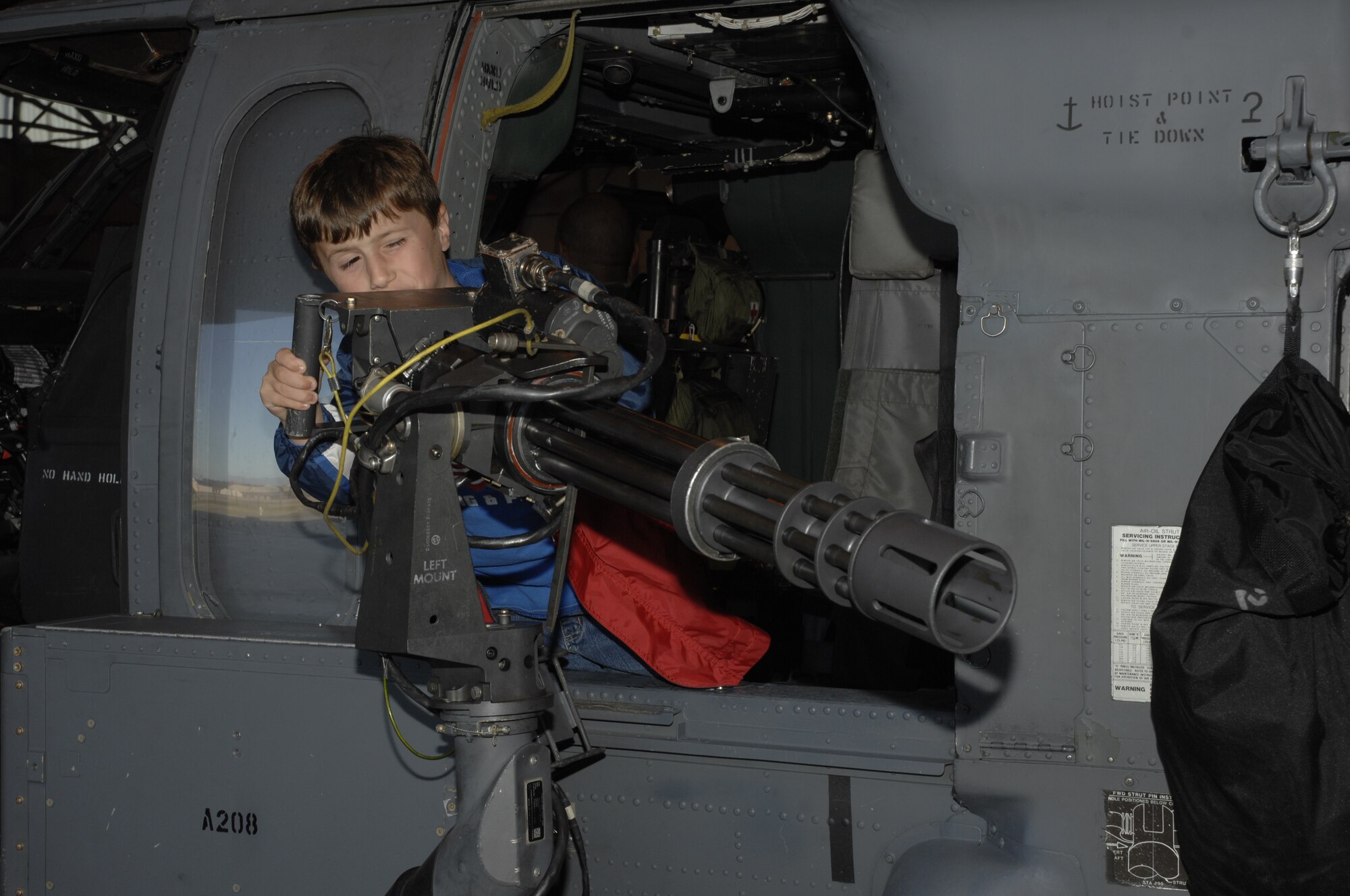 Jonathan Ciero, son of Lt. Col. Mark Ciero 494th Fighter Squadron, experiences what it would be like to be a gunner on an HH60 helicopter Sept. 18. (U.S. Air Force photo by Airman 1st Class Jessica Snow)