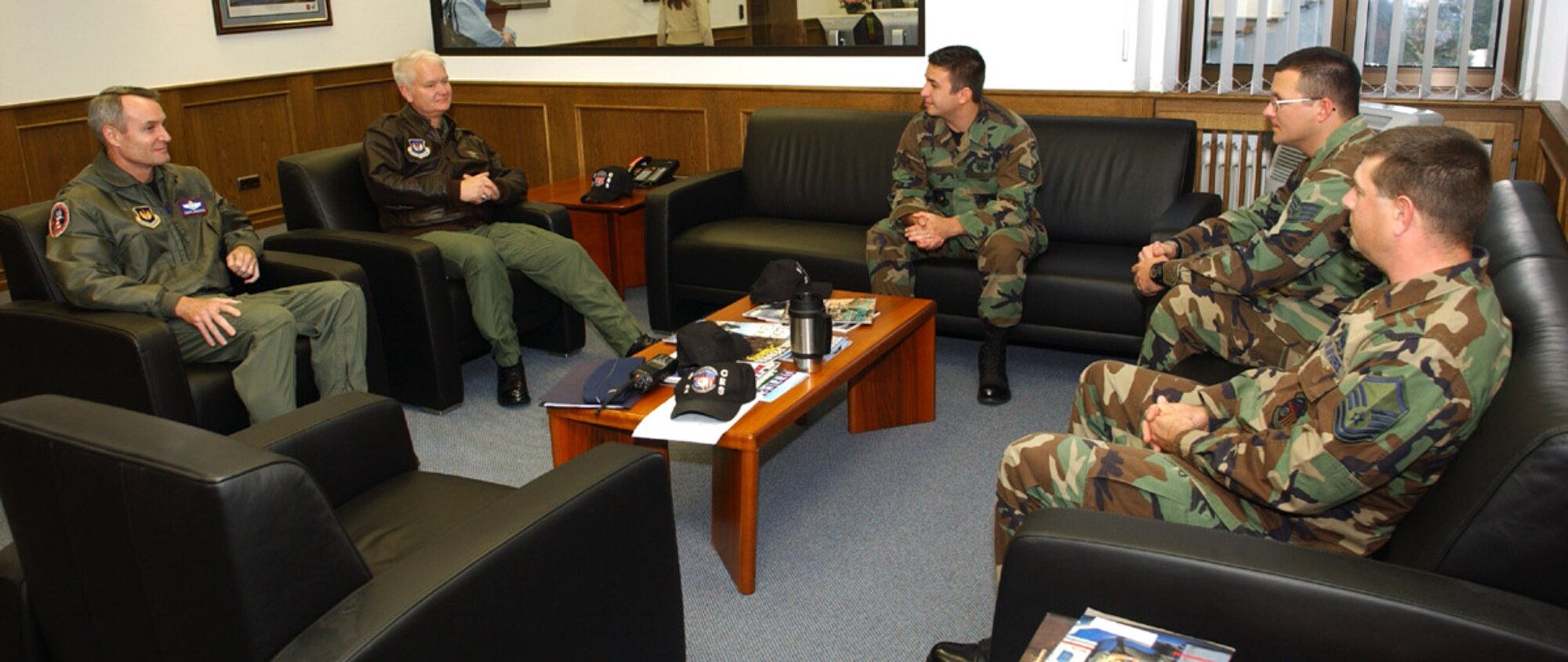 SPANGDAHLEM AIR BASE, Germany -- Lt. Gen. Rod Bishop (second from left), 3rd Air Force commander, and Col. Darryl Roberson, 52nd Fighter Wing commander, talk with three Sabers about their work on a humanitarian deployment to Guinea-Bissau, West Africa. They served on a 10-member team responsible for providing local de-miners in battle area clearance and unexploded ordnance demolition. (U.S. Air Force photo/Airman 1st Class Allen Pollard)