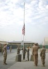 BAGRAM AIR BASE, Afghanistan -- Airmen from the 5th Security Forces Squadron here, conduct reveille while deployed at Camp Cunningham in Bagram, Afghanistan in honor of the Air Force's 60th Anniversary. The deployed security forces team is led by Tech. Sgt. Robert Simpson, 5th Bomb Wing antiterrorism office. (courtesy photo)