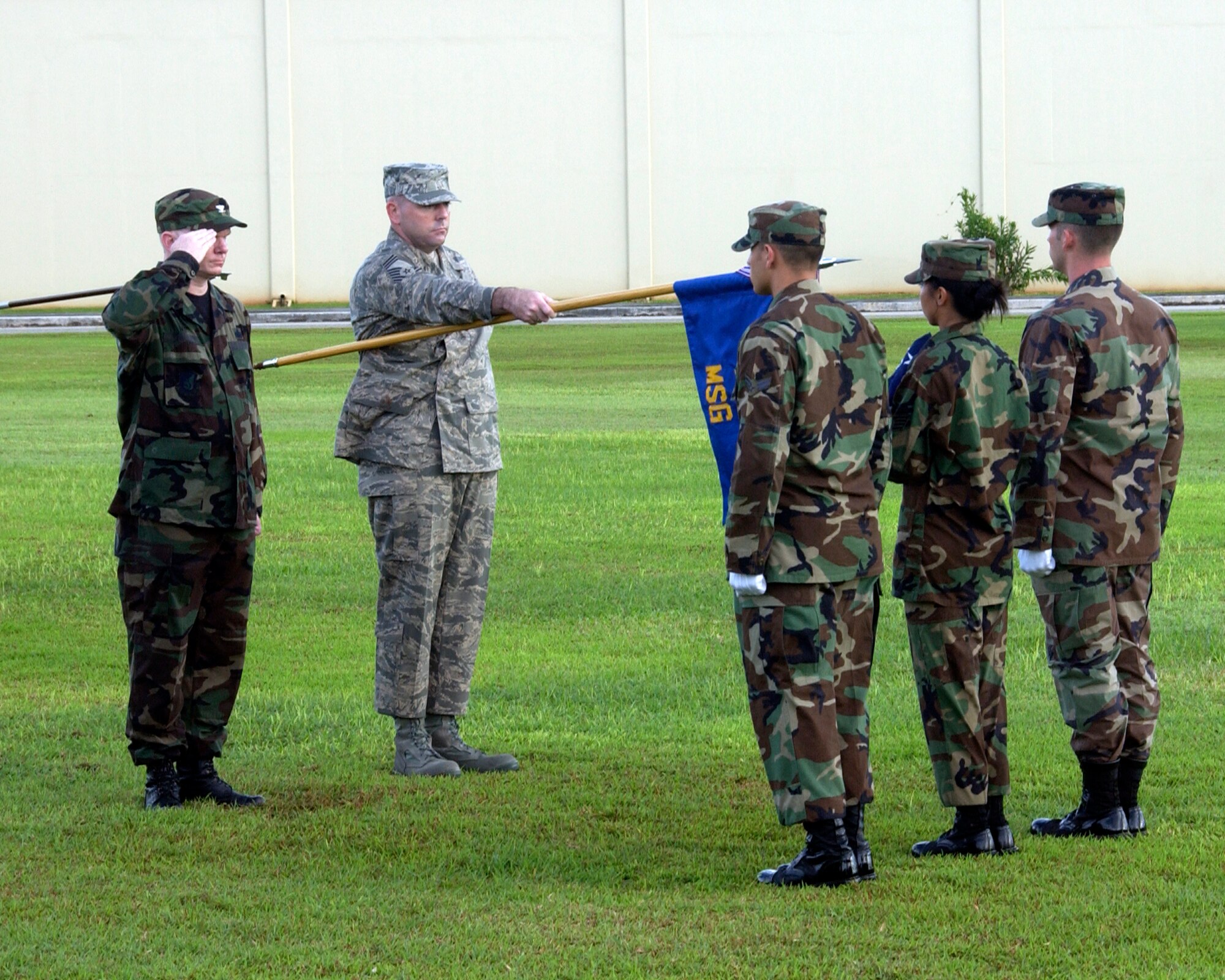 ANDERSEN AIR FORCE BASE GUAM, Colonel Mark Talley, Mission Support Group Commander, and Chief Master Sergeant Joseph Riff, Group Superintendent of the 36th Mission Support Group, pay respect to the flag during the Andersen Air Force Base's POW MIA retreat ceremony. Andersen Air Force base honors the fallen Prisoners Of War and those still Missing In Action with their annual remembrance ceremony.(U.S. Air Force Photo by Technical Sergeant Michael Boquette)(RELEASED)