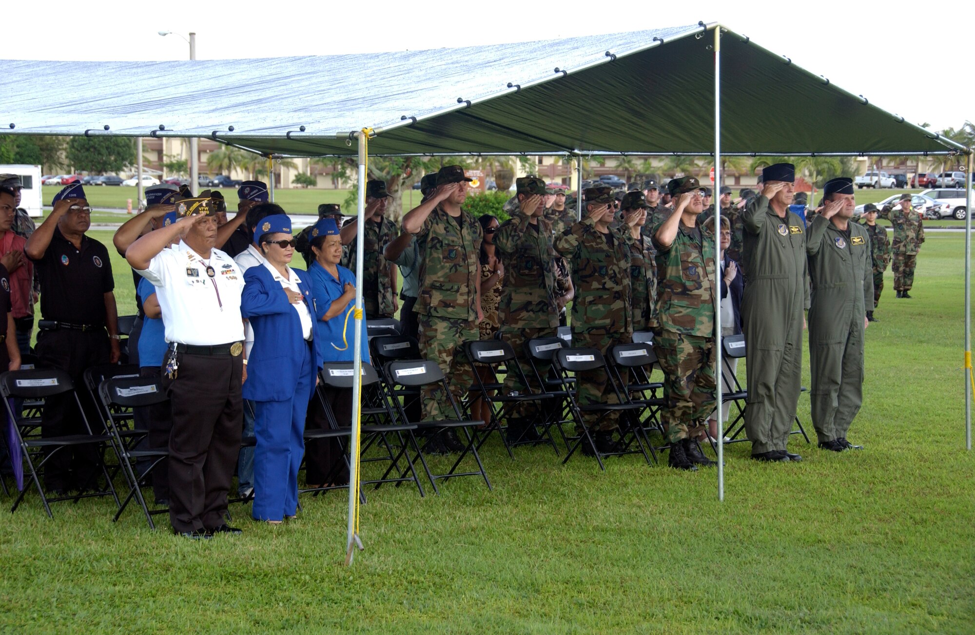 ANDERSEN AIR FORCE BASE GUAM, Distinguished visitors and Honored guests pay respects during the retiring of the colors during the Andersen Air Force Base's POW MIA retreat ceremony. Andersen Air Force base honors the fallen Prisoners Of War and those still Missing In Action with their annual remembrance ceremony.(U.S. Air Force Photo by Technical Sergeant Michael Boquette)(RELEASED)