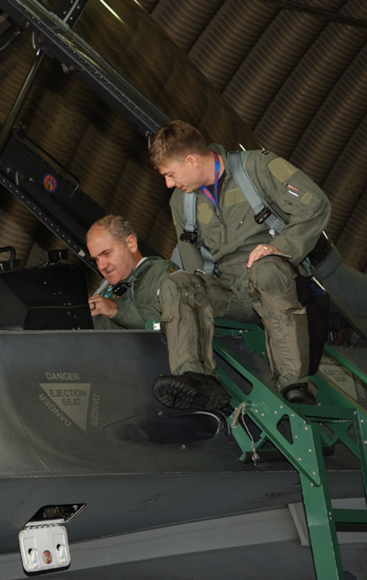 SPANGDAHLEM AIR BASE, Germany -- Capt. James Goeppinger, 23rd Fighter Squadron, helps Lt. Gen. Simeon Hristov Simeonov, Bulgarian air force commander, strap into this seat and explains the layout of the cockpit prior to their F-16 flight Sept. 19, 2007. General Simeonov traveled to Spangdahlem Air Base to for an orientation tour. (U.S. Air Force photo/Airman 1st Class Allen Pollard) 
