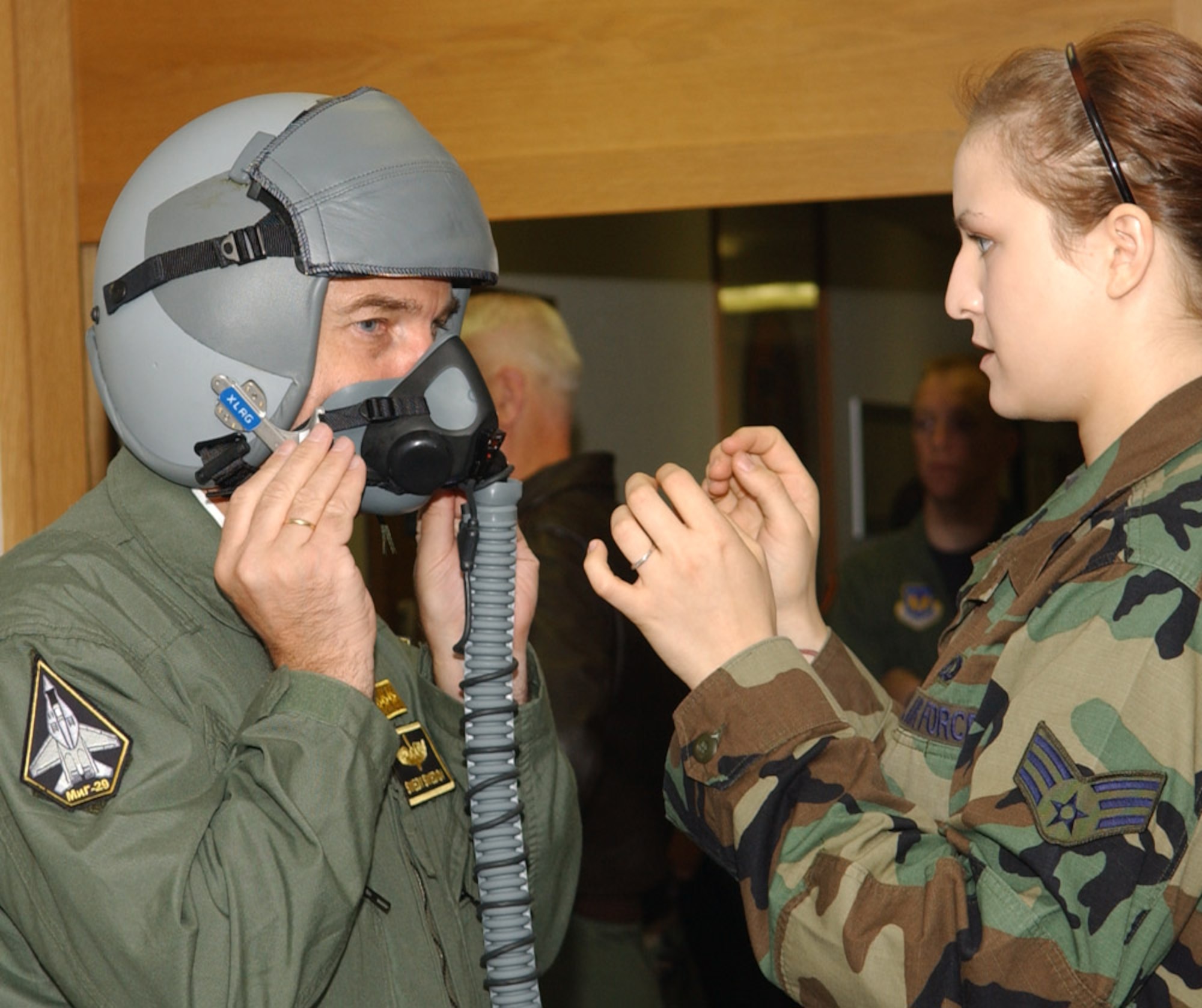 SPANGDAHLEM AIR BASE, Germany – Senior Airman Nicole Vaughn, 23rd Fighter Squadron, assists Lt. Gen. Simeon Hristov Simeonov, Bulgarian air force commander, with a MBU 20/P combat edge mask custom fitting to ensure a proper seal before an F-16 flight Sept. 19, 2007. It is crucial the mask fits properly for the flyer; if it does not, the mission could be negatively impacted. General Simeonov traveled to Spangdahlem Air Base for an orientation tour. (U.S. Air Force photo/Airman 1st Class Allen Pollard) 