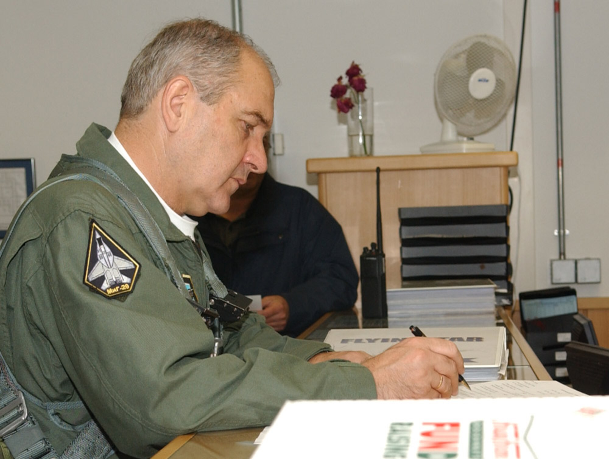 SPANGDAHLEM AIR BASE, Germany – Lt. Gen. Simeon Hristov Simeonov, Bulgarian air force commander, signs flying paperwork required for him to fly Sept. 19, 2007. General Simeonov traveled to Spangdahlem Air Base to for an orientation tour. (U.S. Air Force photo/Airman 1st Class Allen Pollard) 