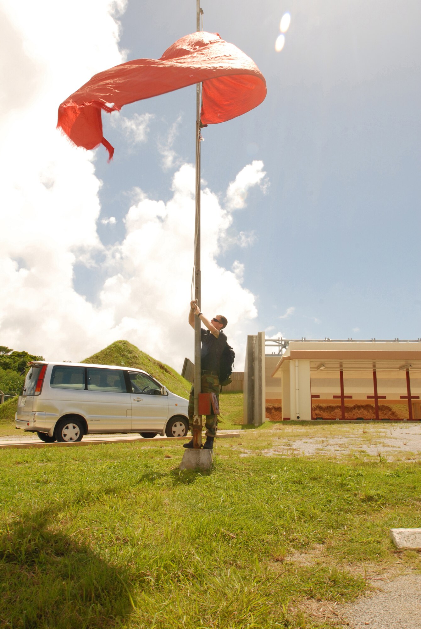 Staff Sgt. Grant Holder  raises the red flag at the shooting range signifying firing is in progress during a combat arms qualification course at Kadena Air Force Base, Japan, Sept.  20, 2007.  Sergeant Holder is assigned to the 18th Security Forces Squadron.  (U.S. Air Force photo/Airman 1st Class Ryan Ivacic)
