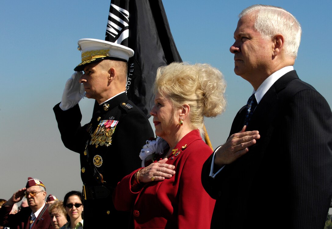 Chairman of the Joint Chiefs of Staff U.S. Marine Gen. Peter Pace, Patricia Scharf, widow of Col. Charles Scharf, and Defense Secretary Robert M. Gates render honors during the national anthem during a POW/MIA Recognition Day ceremony at the Pentagon, Sept. 21, 2007.  