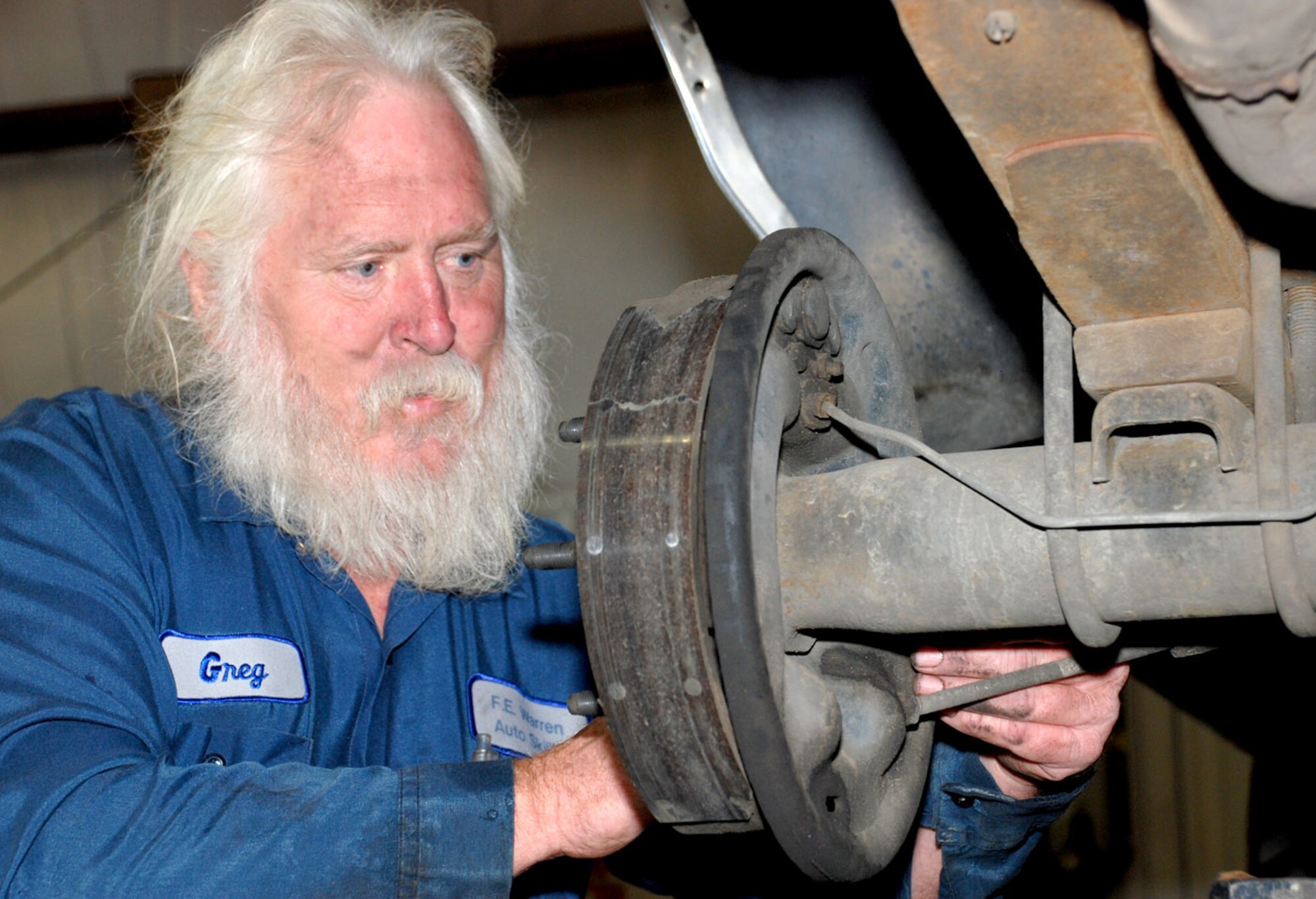 Greg Winters, auto mechanic, changes the brake pads on a vehicle Sept. 7 at the Auto Skills Center here. Mr. Winters retired from the Navy after 21 years of service and has been working here since around 1998 (Photo by Airman 1st Class Daryl Knee).