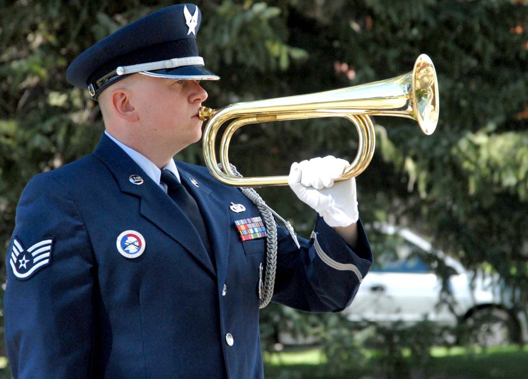 Staff Sgt. Kristopher Bradney, 790th Missile Security Forces Squadron, plays taps during a moment of silence at the 9/11 remembrance service in the Frontier Chapel Tuesday. This year marked the sixth anniversary of the Sept. 11 terrorist attacks in New York, Washington, D.C., and Pennsylvania (Photo by Shelley Raffl).