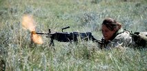 “Terrorist” Airman Lisa Smith, 90th MSFS, fires her weapon at Airmen involved in the scenario during a security exercise Aug. 28 at an abandoned launch facility. The enemies represented current terrorist threats and tested the 790th MSFS member’s tactics response.