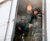 Airman 1st Class Nicholas Harris, 90th Security Forces Group Tactical Response Force, and Senior Airman Jared Sweeney, 790th MSFS, secure the open door to the resource vehicle. The “terrorists” tried to attack the vehicle and take what was inside.