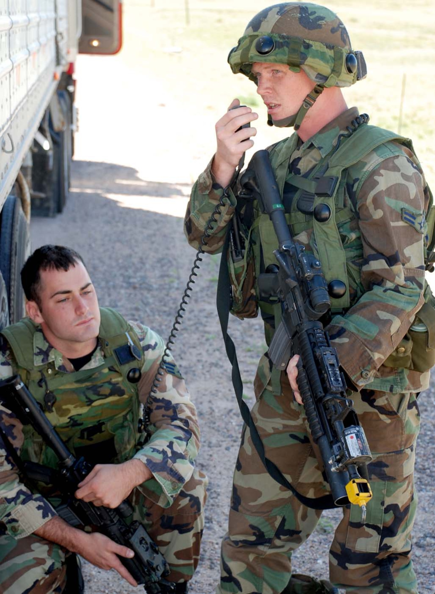 Airman Joseph Urednick, 790th MSFS, radios in his position near the resource vehicle. Team 4 leader Senior Airman Richard Phillips, 790th MSFS, “died” in the attack and kneels in position while help is on the way.