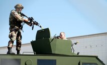 Senior Airman Richard Phillips, 790th Missile Security Forces Squadron, positions himself on the roof of a Bearcat to take out enemy Airman Ryan Maxwell, 90th MSFS. Airman Maxwell and his team commandeered this Bearcat and were using it to pick off members of the 790th MSFS.