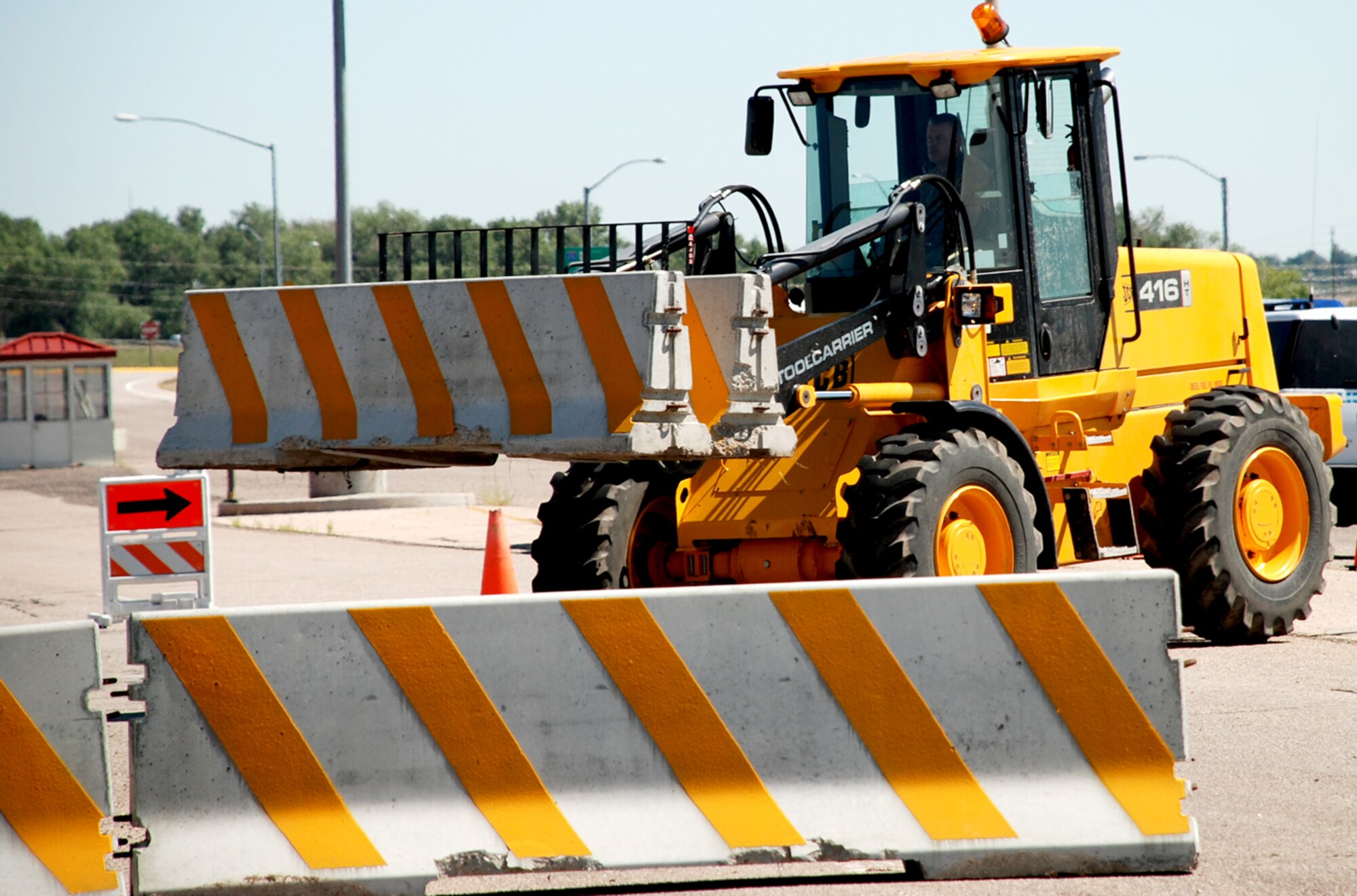 Brian Nichols, 90th Civil Engineer Squadron contractor, operates a forklift to maneuver barriers in front of Gate 2 Aug. 30. Warren members practiced implementing the barrier plan for the upcoming nuclear surety and operational readiness inspections this month (Photo by 2nd Lt. Lisa Meiman).
