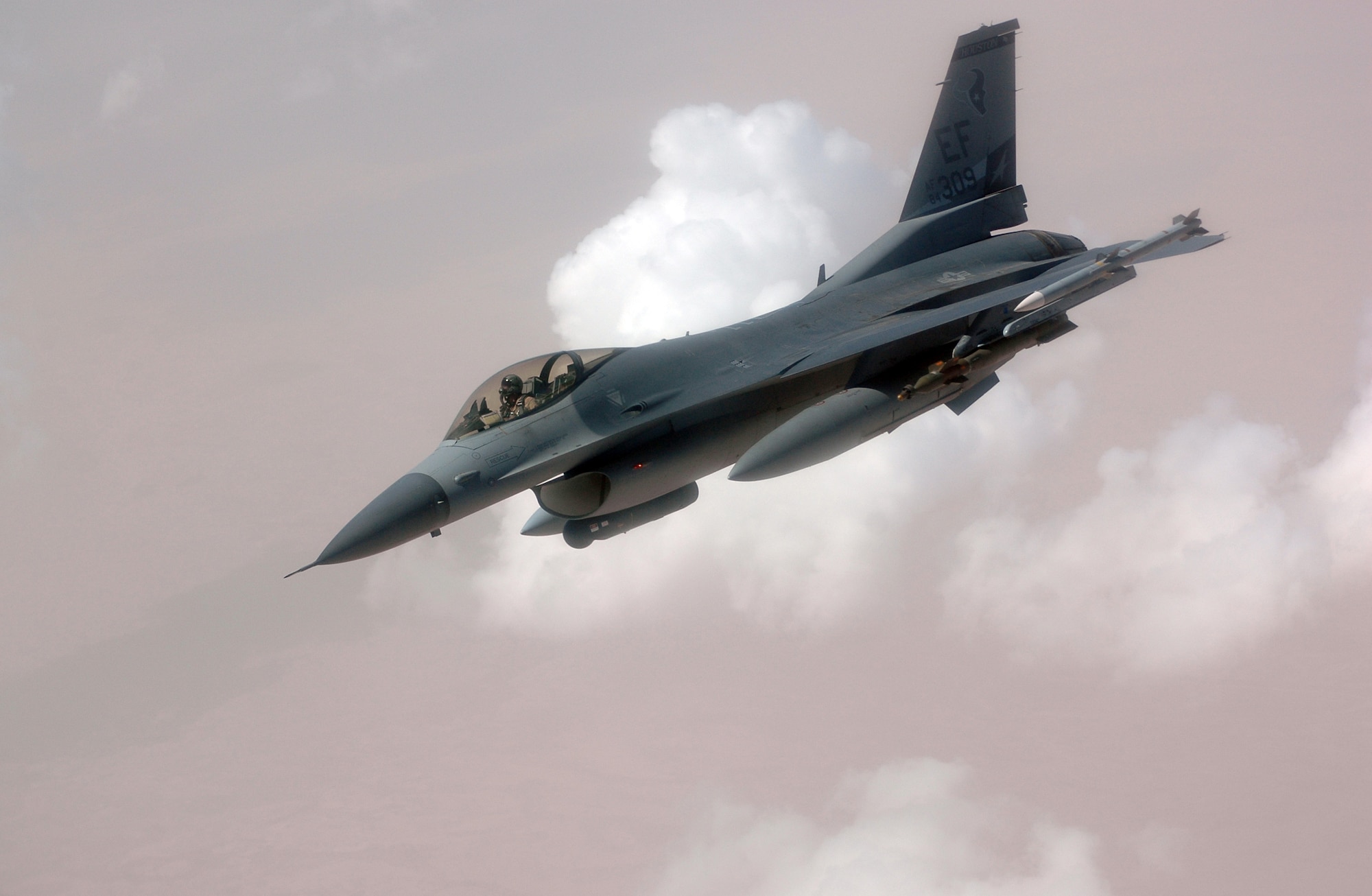 An F-16 Fighting Falcon turns away after a mid-air refueling over Southwest Asia.  The F-16 Fighting Falcon is a compact, highly maneuverable multi-role fighter and has proven itself in air-to-air combat and air-to-surface attack. It provides a relatively low-cost, high-performance weapon system for the United States and allied nations.  (U.S. Air Force photo/Staff Sgt Grady Epperly)