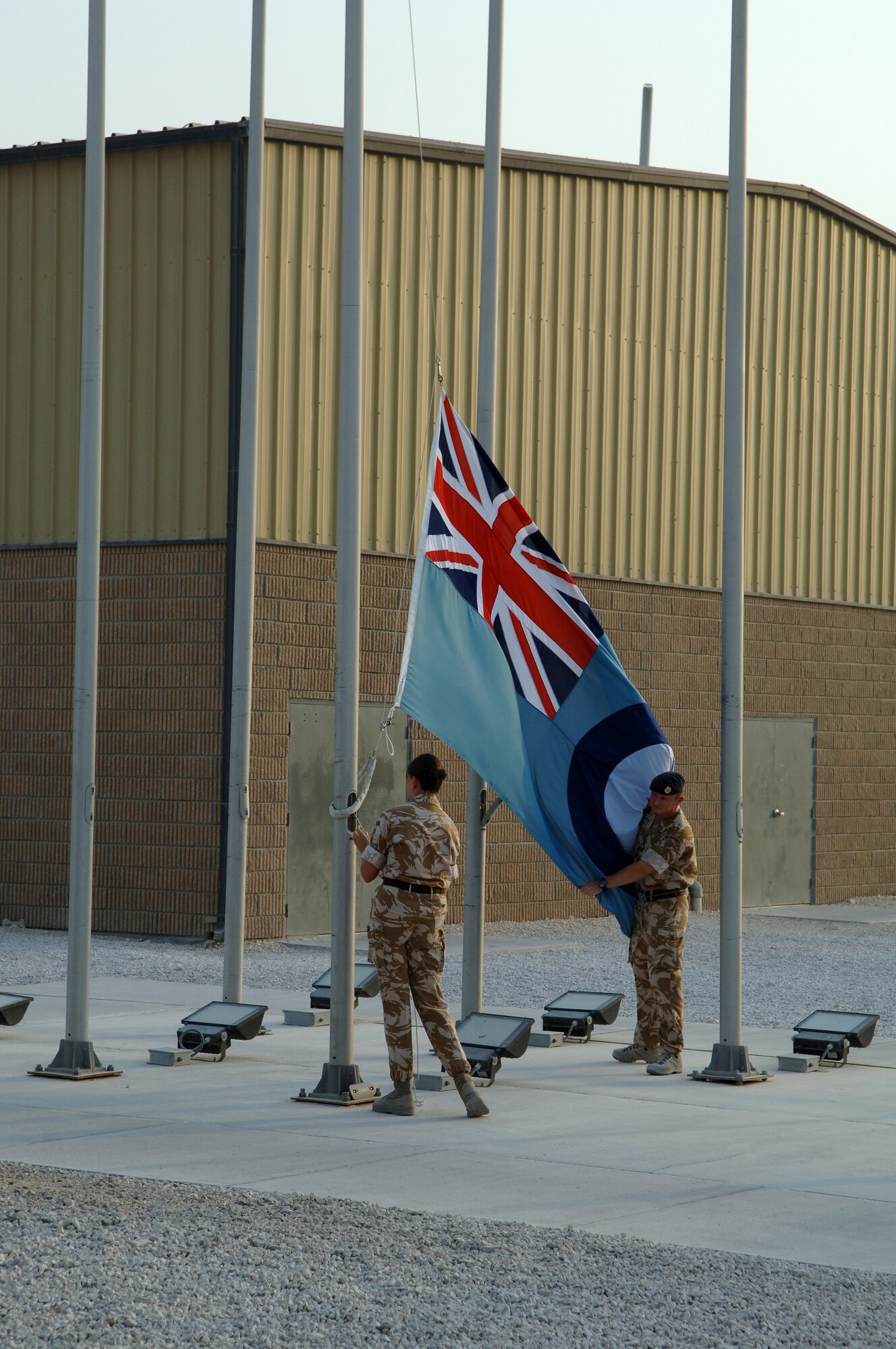 SOUTHWEST ASIA -- Members of the Royal Air Force prepare to fold their flag at the conclusion of the Battle of Britain ceremony Sept. 15. (U.S. Air Force photo/Master Sgt. Greg Kunkle)