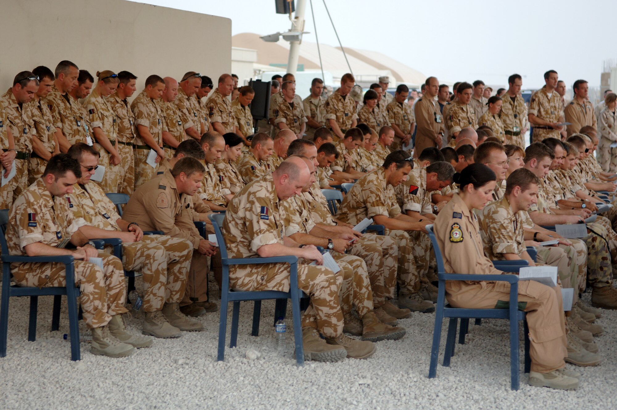 SOUTHWEST ASIA -- Members of the Royal Air Force bow their heads during a prayer and a moment of silence to remember those who lost their lives during the Battle of Britian. (U.S. Air Force photo/Maste Sgt. Greg Kunkle)