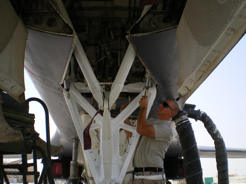 SOUTHWEST ASIA -- Airman 1st Class Thomas Melton, 379th Expeditionary Aircraft Maintenance Squadron, inspects the nose landing gear strut actuators during the extensive rebuilding of a B-1 Lancer landing gear assembly and associated components. (U.S. Air Force photo/Lt. Col. Scott Fike)