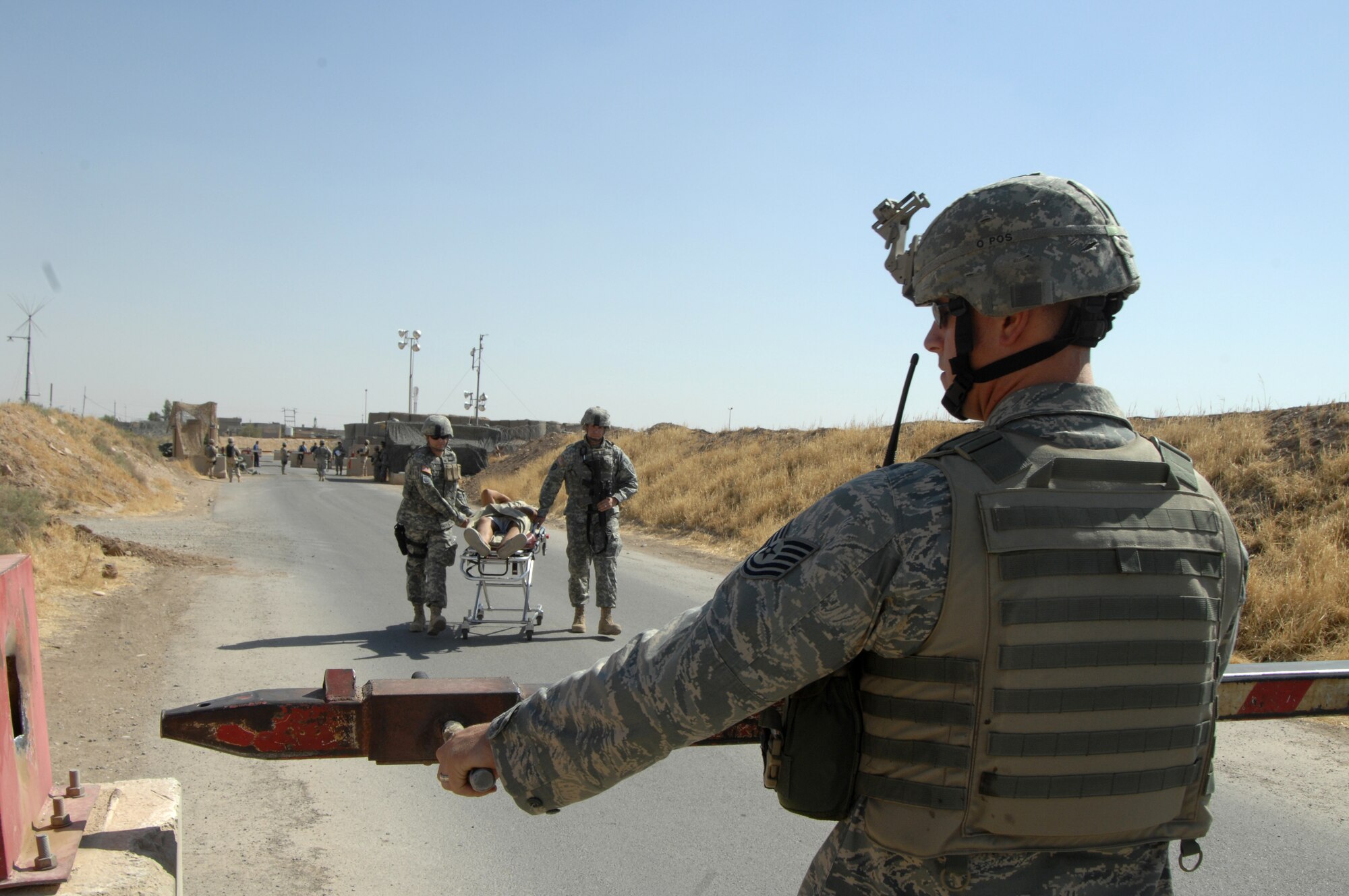 070920-F-0523M-078
KIRKUK REGIONAL AIR BASE, Iraq - Tech. Sgt. Daniel Paus, 506 Air Expeditionary Group Security Forces, opens a gate allowing Army medical personnel to bring in wounded Turkish nationals for medical evacuation back to thier home country.  All injured citizens were evaluated and cared for by Army and Air Force medical  personnel before being taken to the flightline and handed over to the Turkish Air Force. More than 15 Turkish citizens were evacuated on a Turkish Air Force medevac from Kirkuk.
U.S. Air Force photo by Senior Airman Jeremy McGuffin  