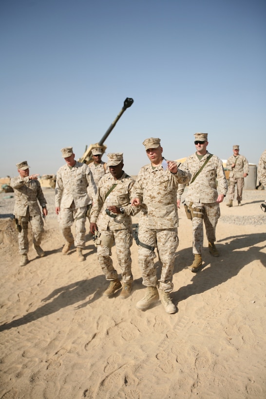 First Sgt. Russel A. Strack, battery first sergeant, Battery T, 5th Battalion, 10th Marine Regiment, Regimental Combat Team 6, gives an area brief to Sgt. Maj. of the Marine Corps Carlton W. Kent aboard Camp Fallujah, Iraq, September 23. After Kent's visit with artillery and infantry Marines throughout the RCT-6 area of responsibility, he held a town hall-style meeting with Marines and sailors to address changes coming down the pipeline and answer Marines' questions. Heavy on the top enlisted Marine's agenda was the issue of retention of first-term Marines, which he said is essential to the commandant's guidance to grow the Marine Corps by 27,000 Marines.
