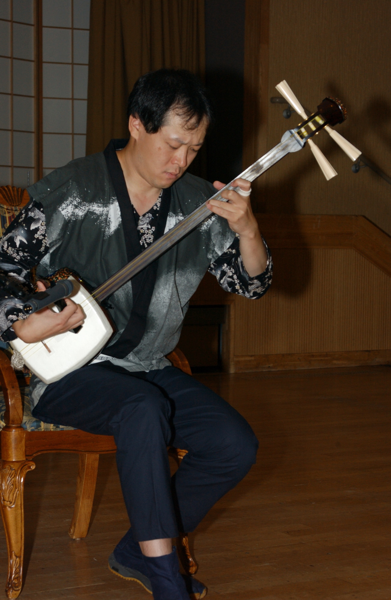 MISAWA AIR BASE, Japan -- Shigenori Wada, 35th Civil Engineering Squadron, plays the shamisen at the 60th Air Force Ball here Sept. 21, 2007. The Air Force Ball is held annually to celebrate the birthday of the United States Air Force.
(US Air Force photo by Airman 1st Class Eric Harris)