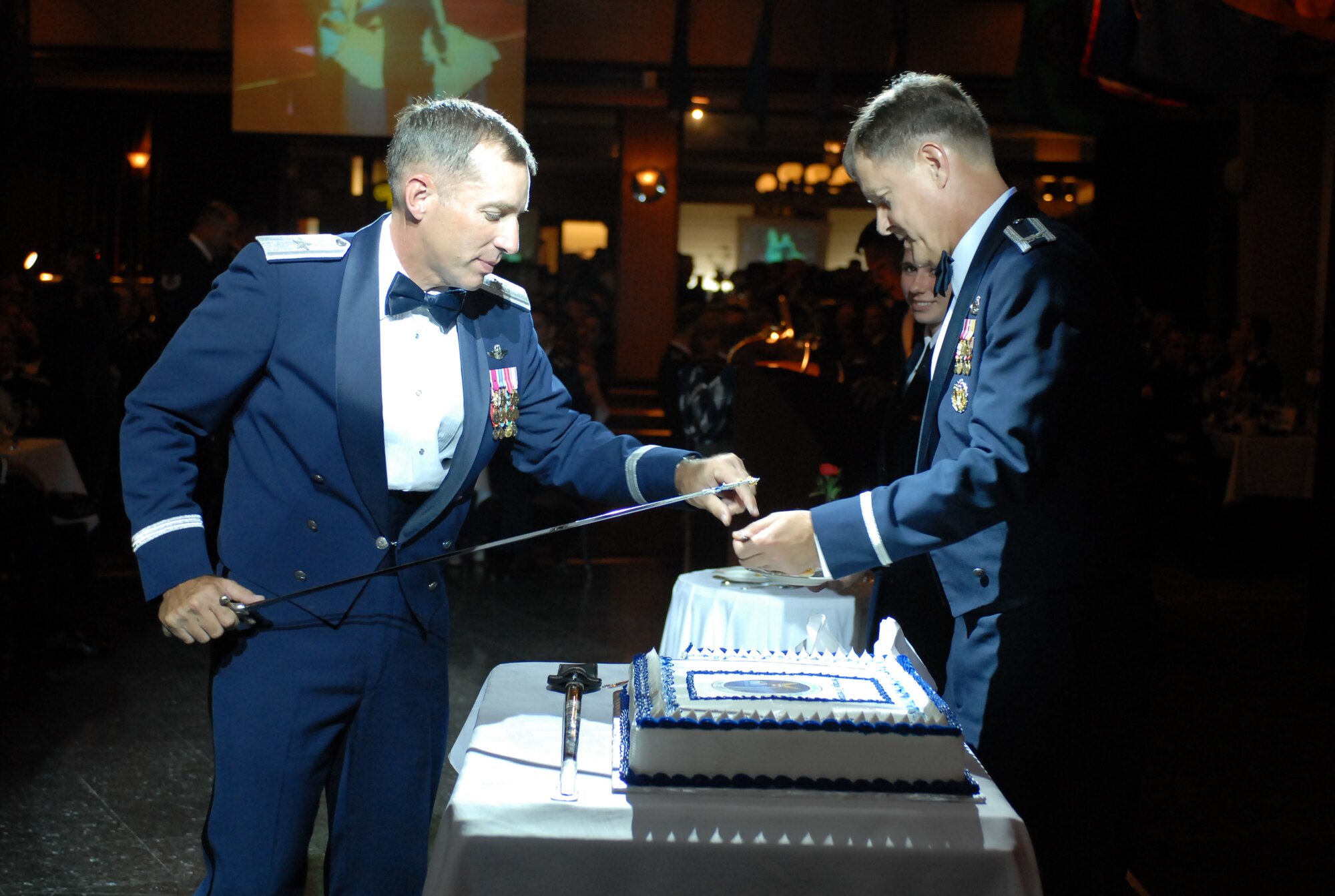 Brig. Gen. Brett T. Williams, 18th Wing commander and Col. John Harris, 18th Mainenenance Group commander, prepare to cut the cake during the Air Force's 60th Anniversary Ball at Kadena Air Base, Japan, Sept. 22, 2007.  The evening consisted of toasts, video presentations, guest speakers, skits and live music.  More than 800 military members and their guests from all four services, the local community and Japanese Self Defense Force attended the annual event.  (U.S. Air Force photo/ Airman 1st Class Kelly Timney) 