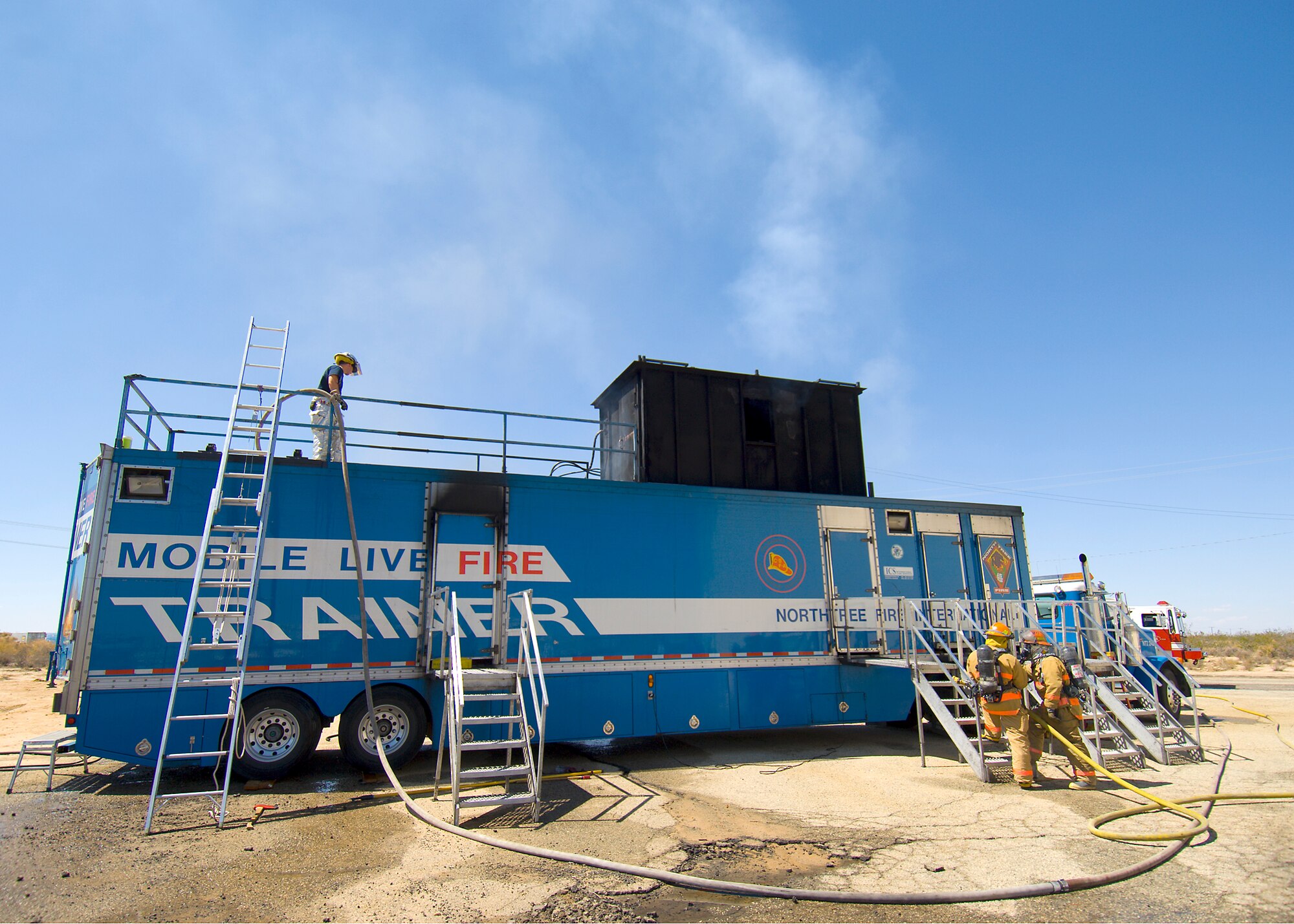 Edwards firefighters train in the interior structural fire trainer here Sept. 10. The training is an Air Force and National Fire Protection Association requirement for fire department personnel to maintain their Firefighter 1 and 2 certifications. (Photo by Mike Cassidy)