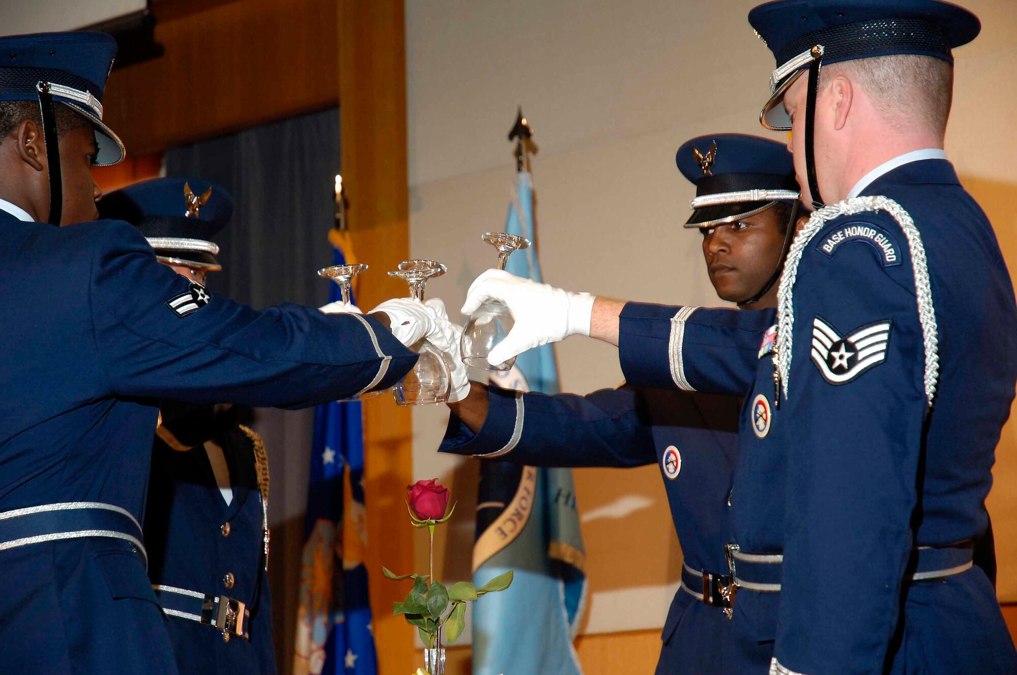 In a solemn ceremony at the start of the Air Force Ball, Tinker Honor Guard members inverted glasses at an empty table, a reminder of the prisoners of war and those mission in action from all branches of service. Honor Guard members from left, are; Airman 1st Class Willie Hart, Master Sgt. Jay Brimmer, Staff Sgt. Ezra Atkins and Staff Sgt. Kenneth Oellien. (Air Force photo by Dave Faytinger)