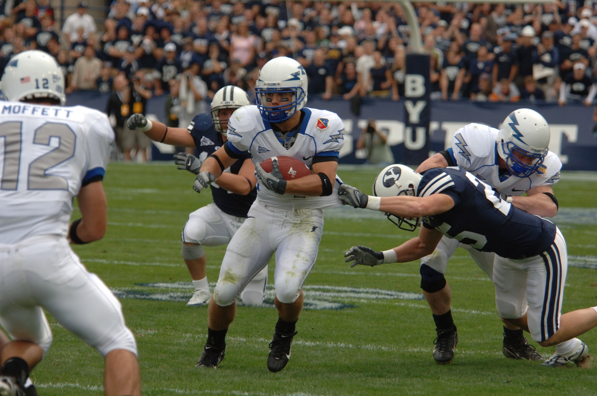 Air Force wide receiver Chad Hall is grabbed by Brigham Young defensive back Quinn Gooch during BYU's 31-6 win Sept. 22 in Provo, Utah. Hall caught six passes for 80 yards and ran twice for 19 more. (U.S. Air Force photo/John Van Winkle) 
