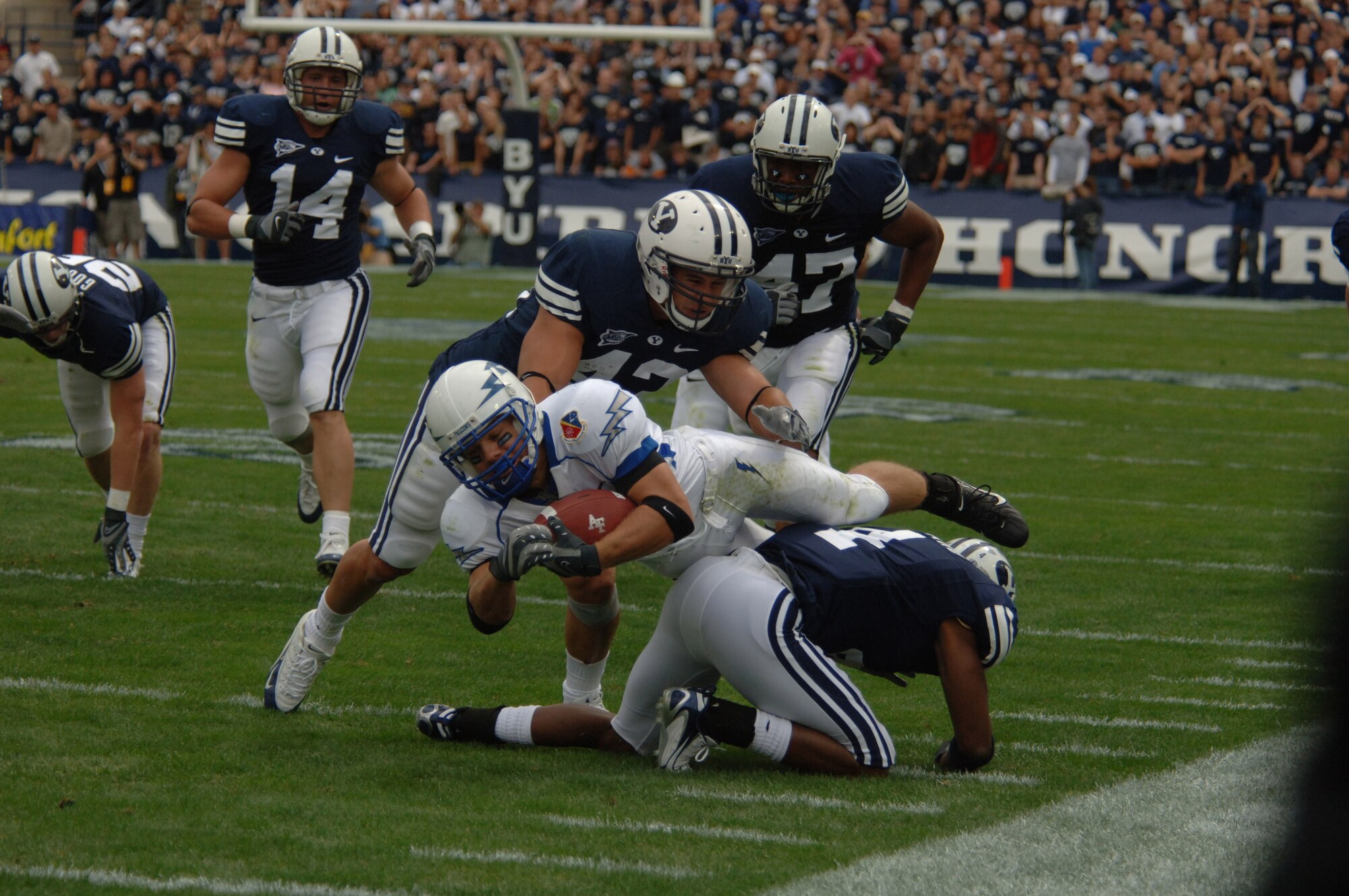 Air Force wide receiver Chad Hall gets sandwiched between Brigham Young linebacker Shawn Doman, 42, and defensive back Brandon Howard, 4, during BYU's 31-6 win Sept. 22, in Provo, Utah. The Falcons converted only 6-of-18 third down attempts. (U.S. Air Force photo/John Van Winkle) 
