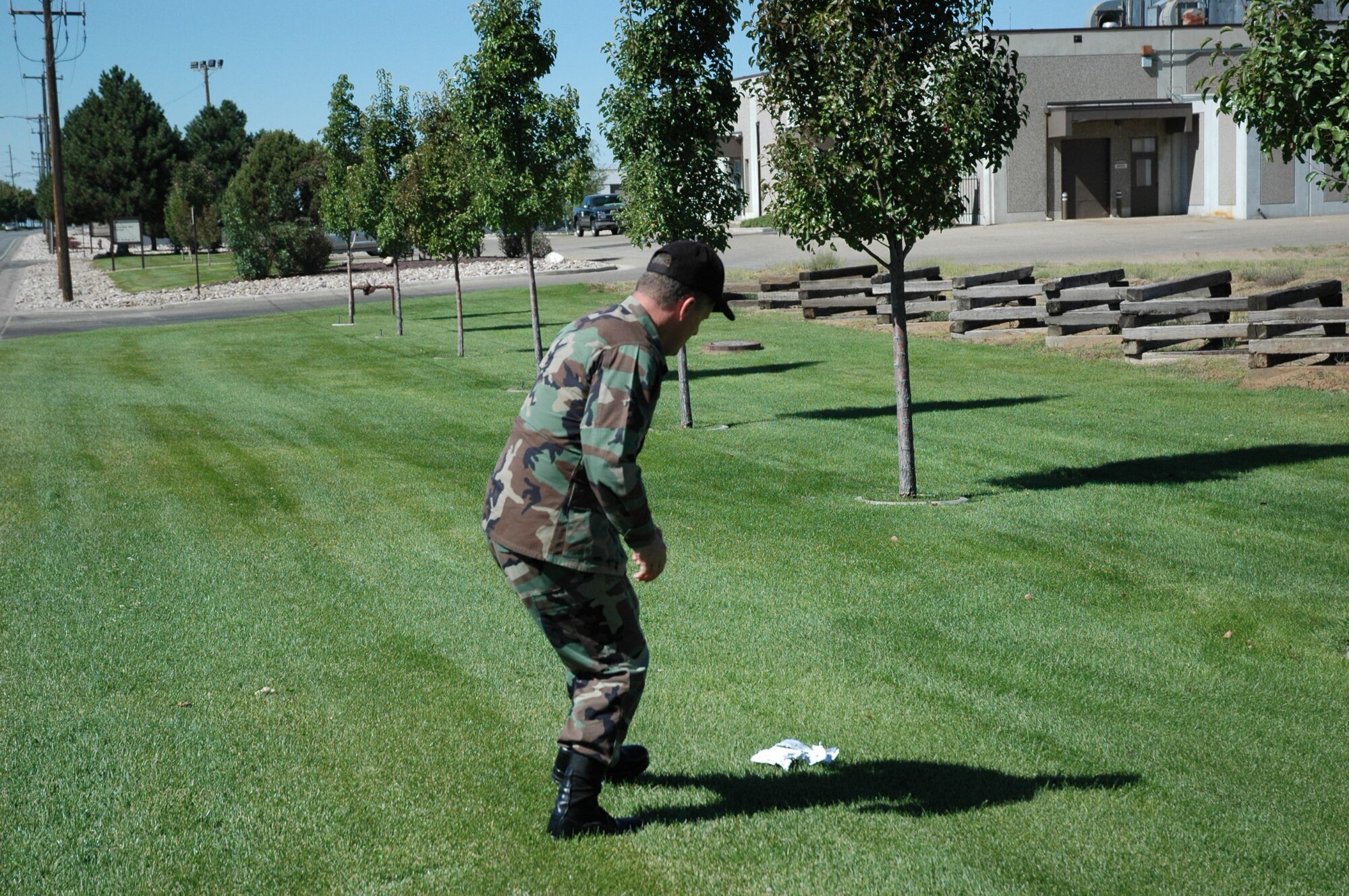 HILL AIR FORCE BASE, Utah-- Col. Scott Chambers, 75th Air Base Wing commander, literally pulls off the side of the road to pick up a piece of trash on the base.  The commander believes in creating a beautiful environment to work and live in. (U.S. Air Force photo by Capt. Genieve David)