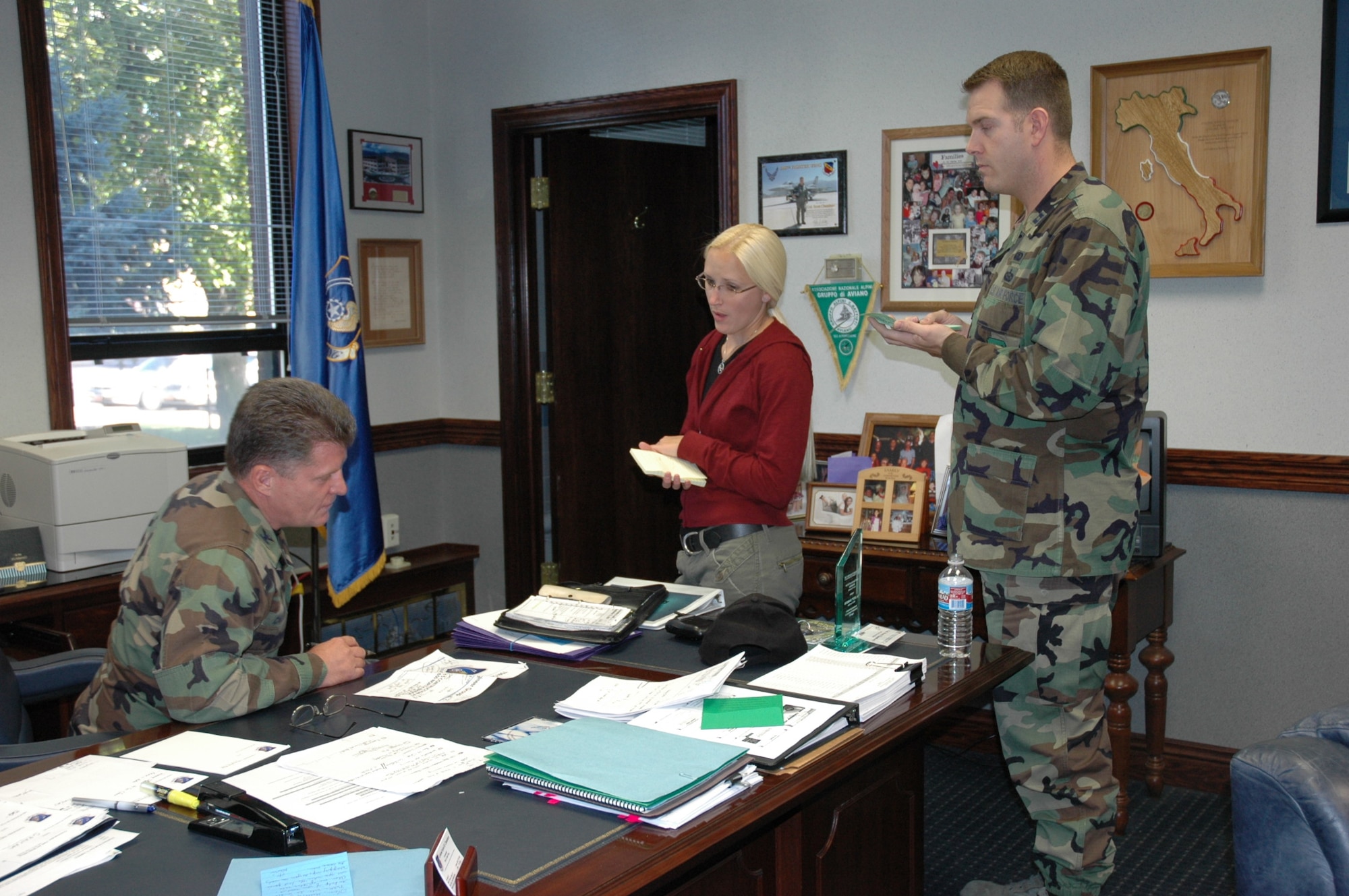 HILL AIR FORCE BASE, Utah-- Col. Scott Chambers, 75th Air Base Wing commander, sounds off a laundry list of to do's for his secretary Amy Mecham and wing executive officer Capt. Kevin Jernigan. (U.S. Air Force photo by Capt. Genieve David)