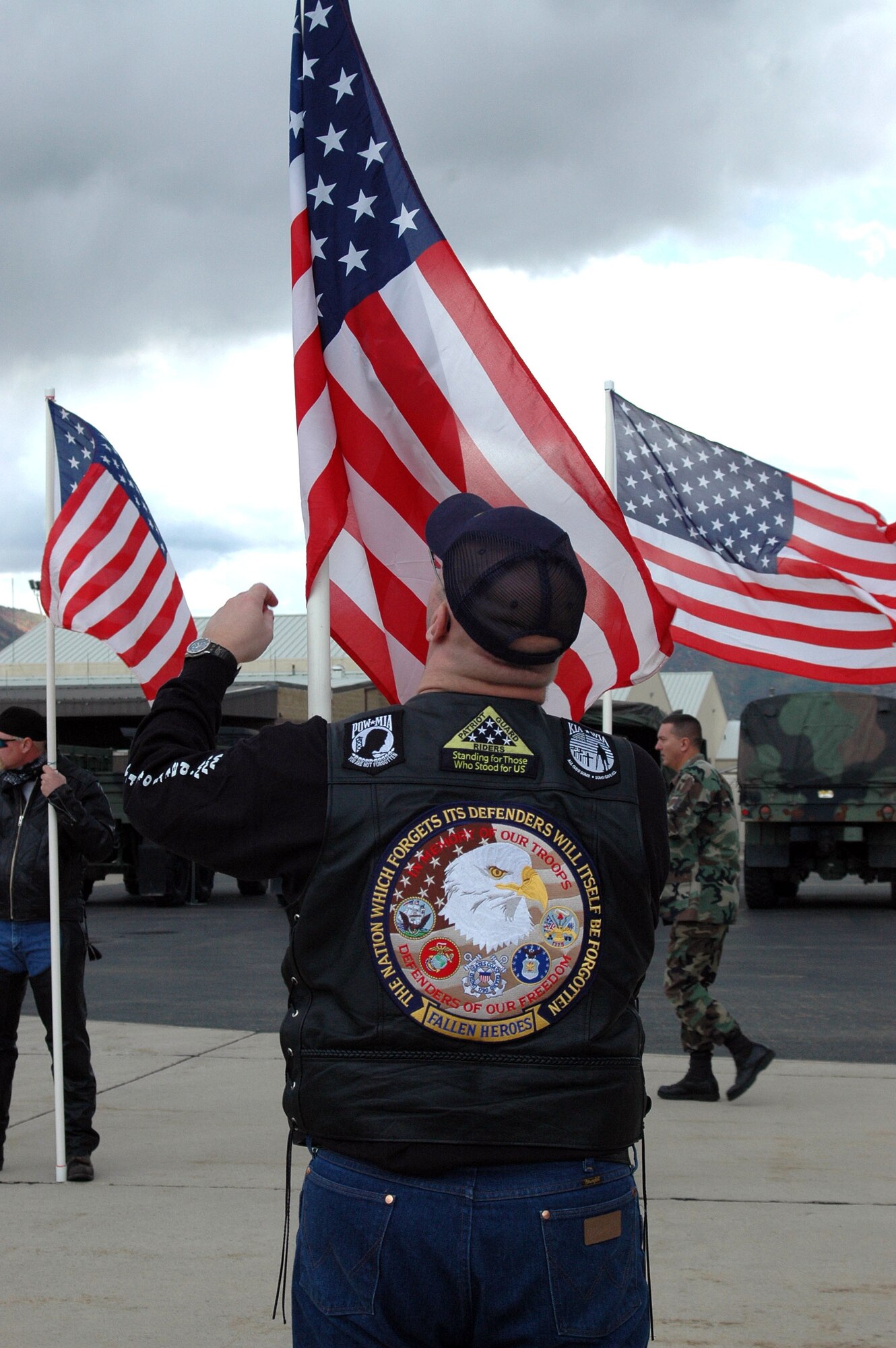 A member of the Patriot Guard Riders fixes his flag while waiting for the arrival of the 729th Air Control Squadron's aircraft to arrive on the flighline. The 729th ACS returned home after a four-month deployment to Balad Air Base, Iraq. 