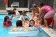 SOTO CANO AIR BASE, Honduras -- Air Force Tech. Sgt. Cheryl Fullen, Joint Security Forces, plays with Honduran children excitedly swimming in the base pool.  Approximately 90 children from Nuestra Señora de Guadalupe Children's Home in Comayagua came out to enjoy the Annual Kids Day celebration September 22.  (U.S. Air Force photo by Staff Sgt. Austin M. May)